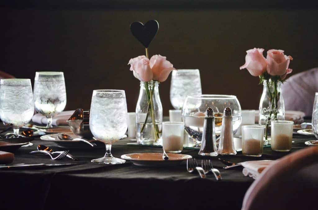 Black and pink themed table scape referencing a wedding seating chart