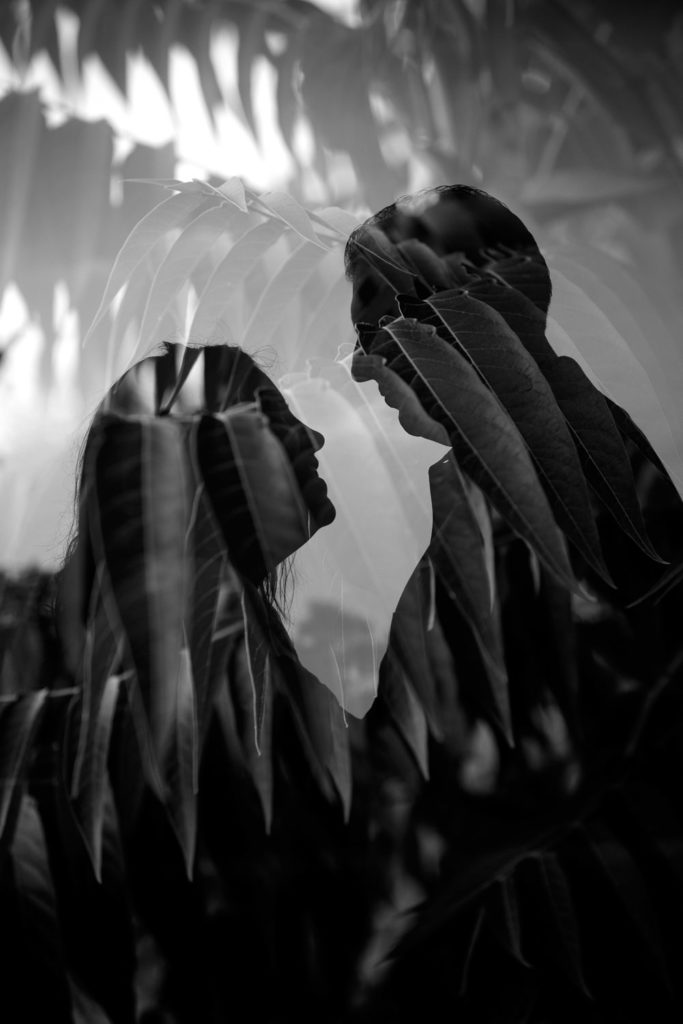 Riverfront Park double exposure of engaged couple silhouettes and palm leaves