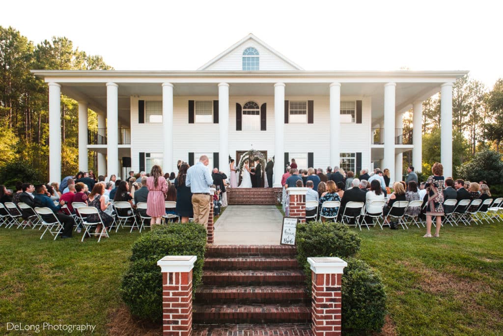Wide angle of main house set up for outdoor wedding ceremony at Rosewood on Country Club by Charlotte Wedding Photographers DeLong Photography