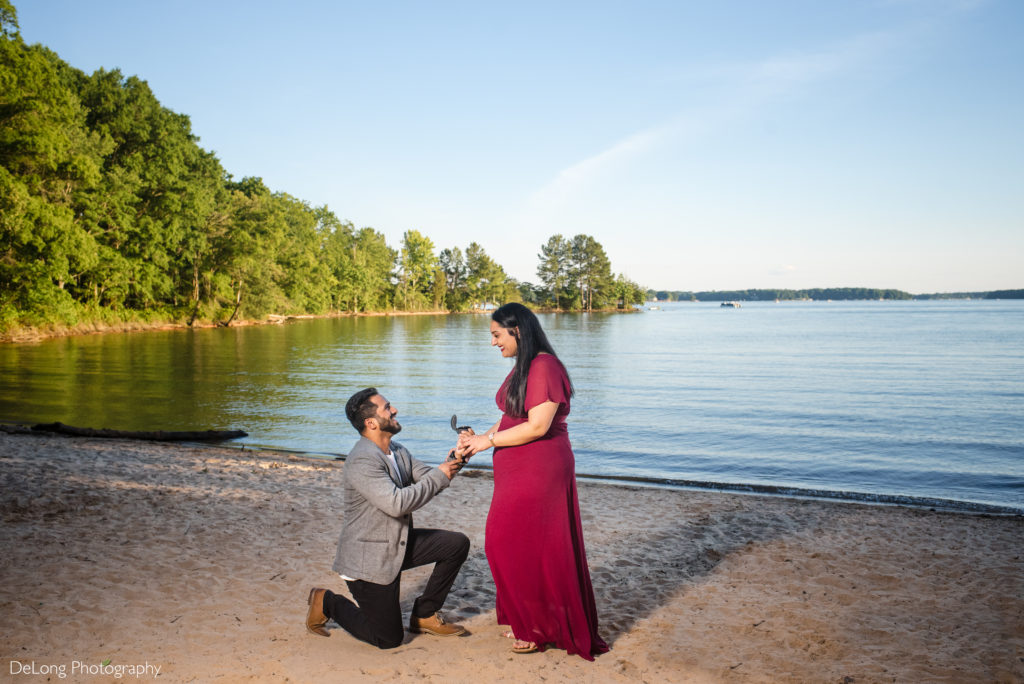 Indian man one one knee one beach during a surprise proposal at Jetton Park