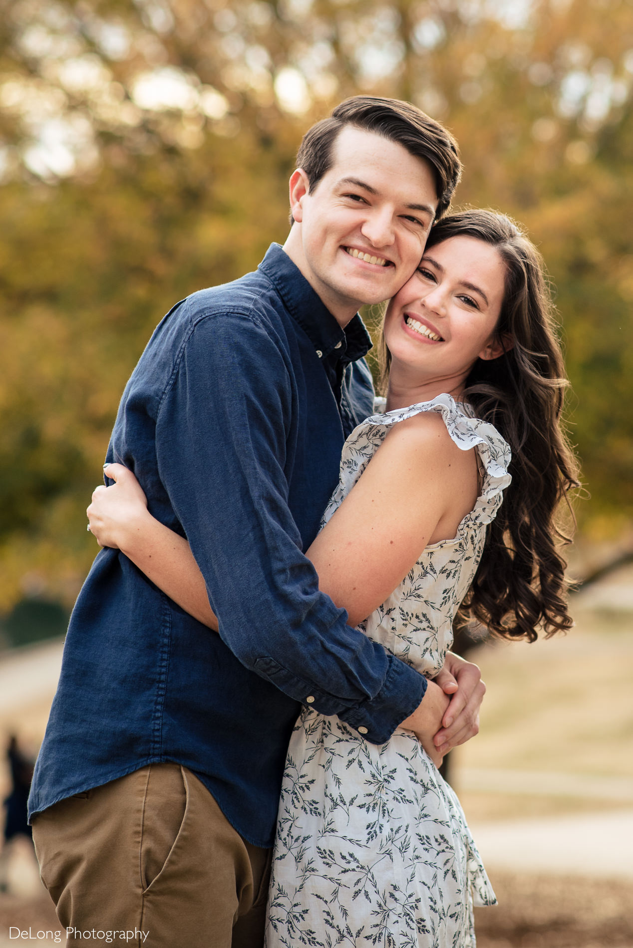 Engaged couple outside at a Freedom park in Charlotte, NC by Charlotte Wedding Photographers DeLong Photography