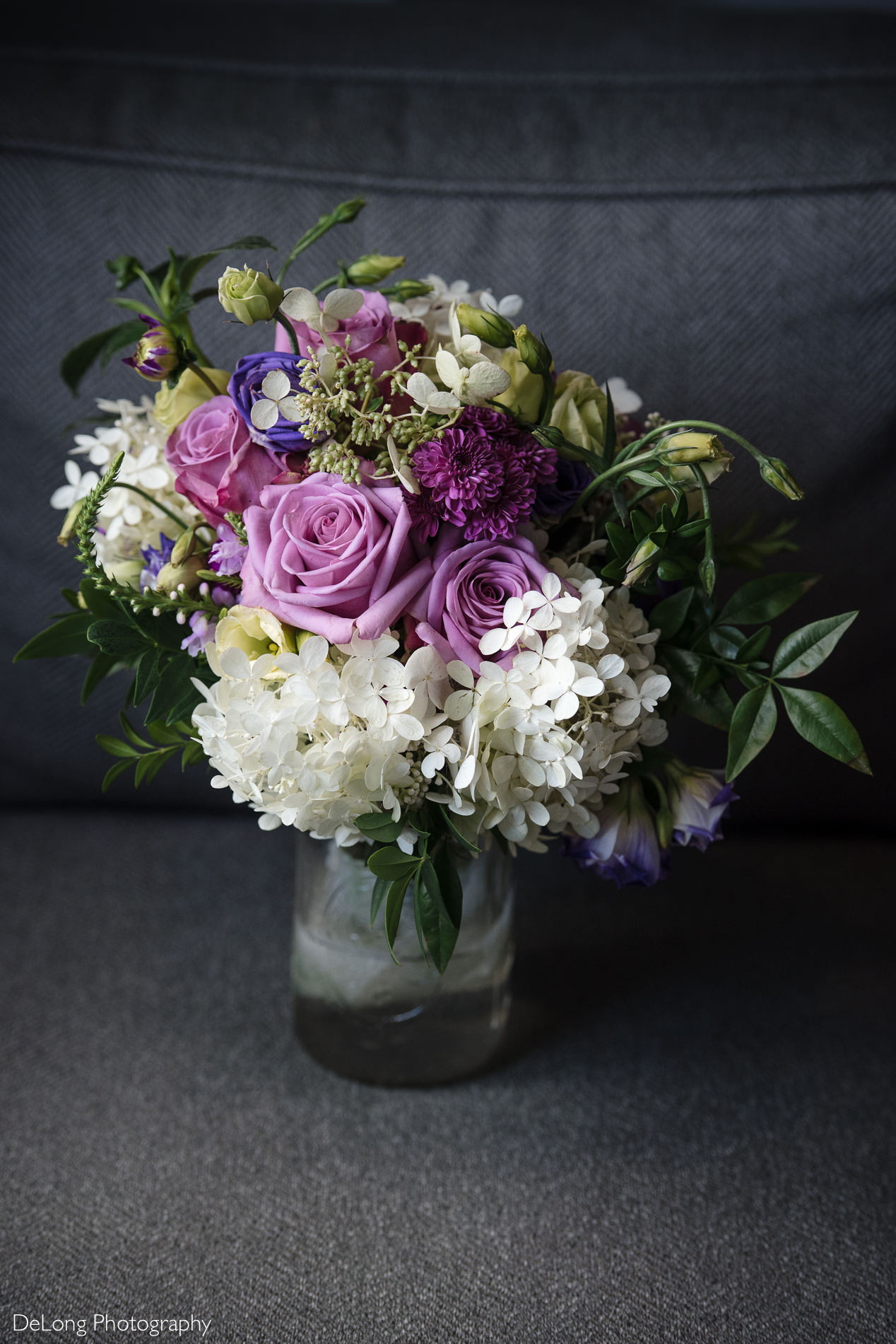 Purple and white bride's bouquet by Charlotte wedding photographers DeLong Photography