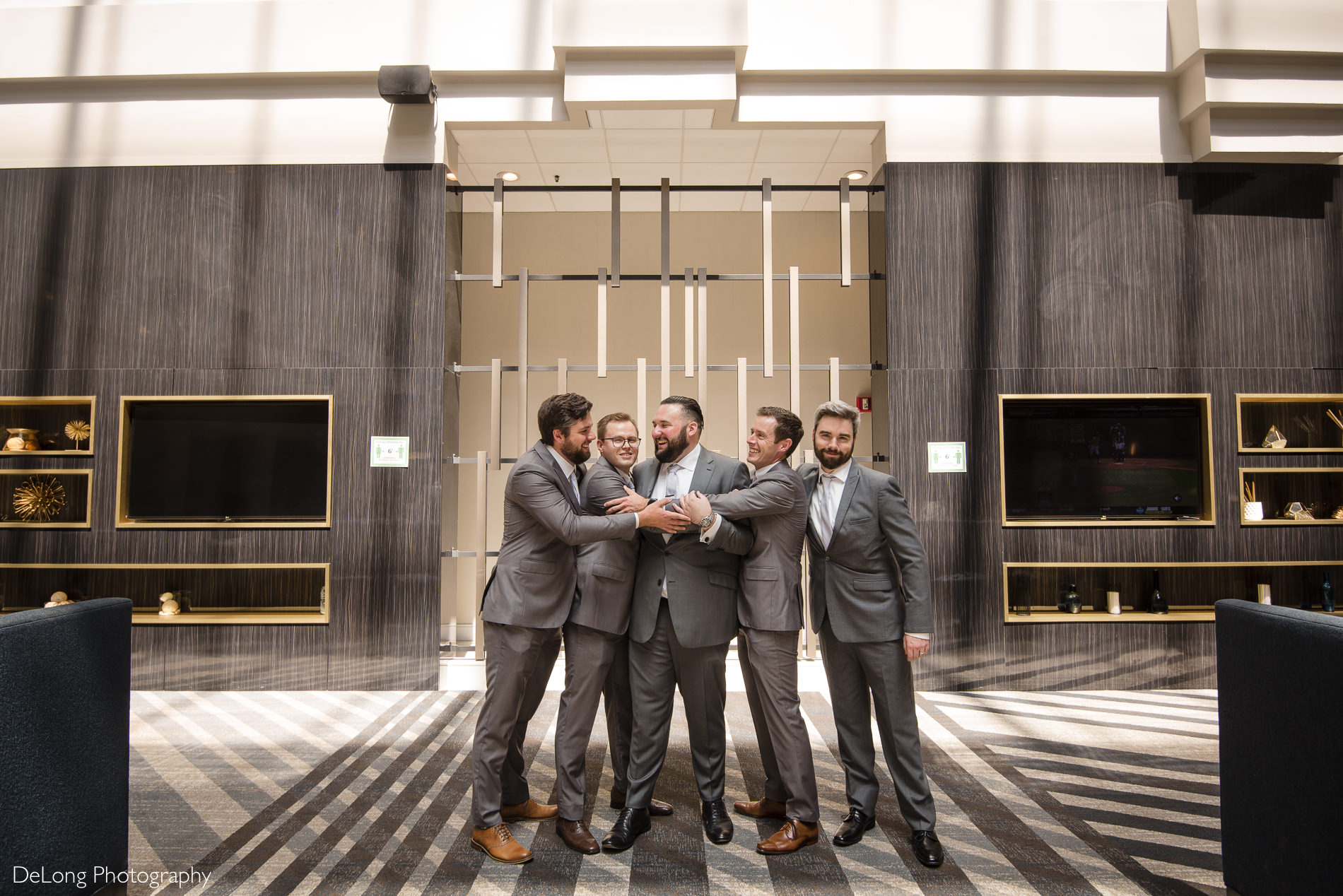 Groom and groomsmen image at the Embassy Suites by Hilton Charlotte  by Charlotte wedding photographers DeLong Photography
