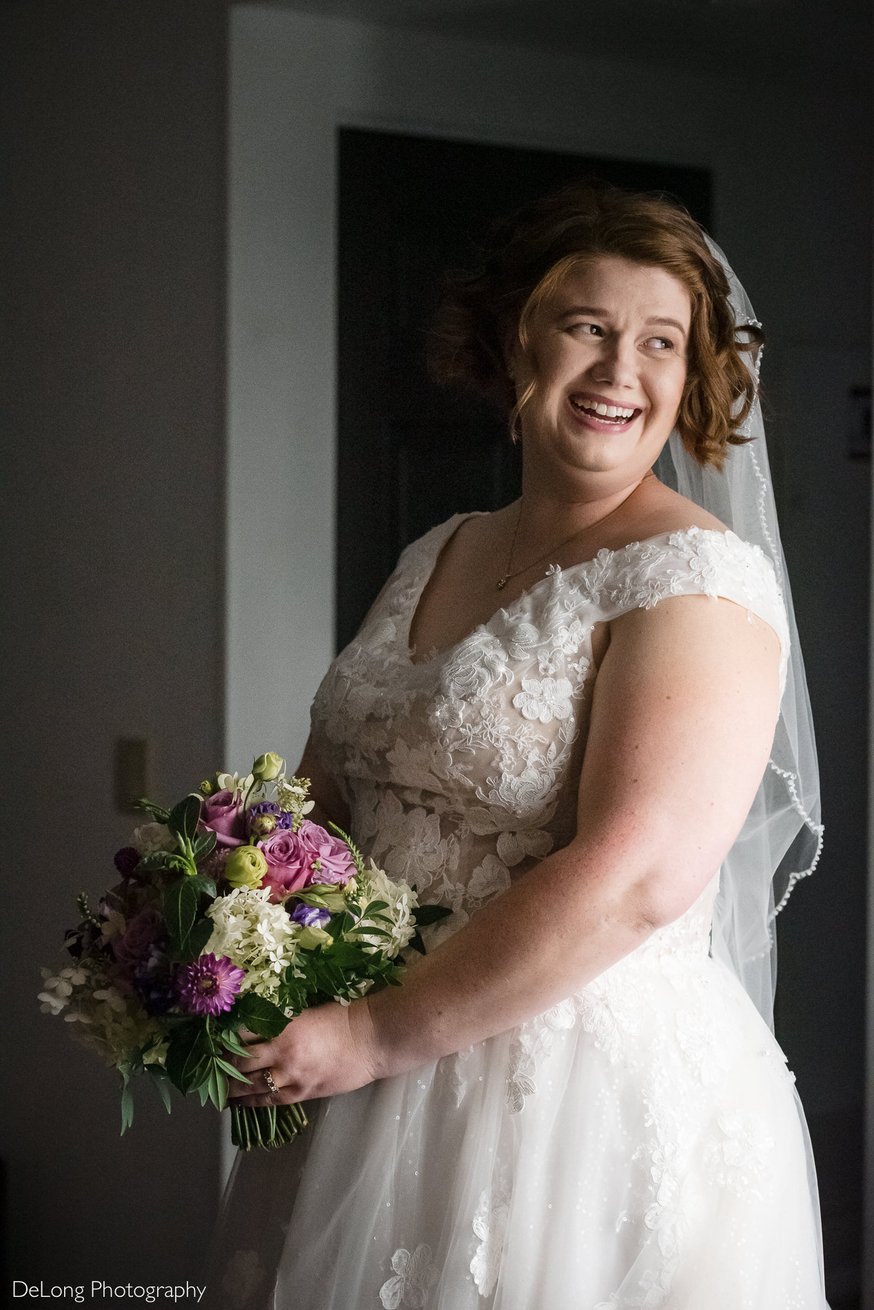 Bridal portrait near window at the Embassy Suites by Hilton Charrlotte location by Charlotte wedding photographers DeLong Photography