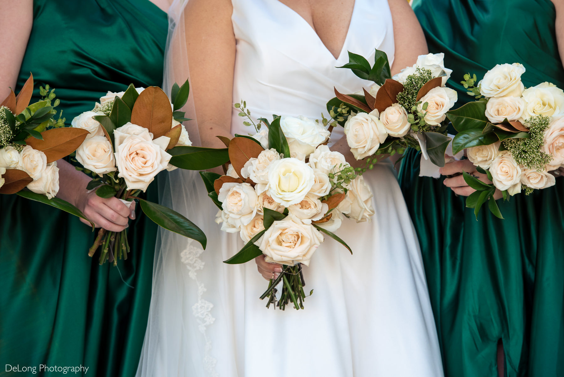 Bride and bridesmaids magnolia and rose bouquets by Charlotte Wedding Photographers DeLong Photography