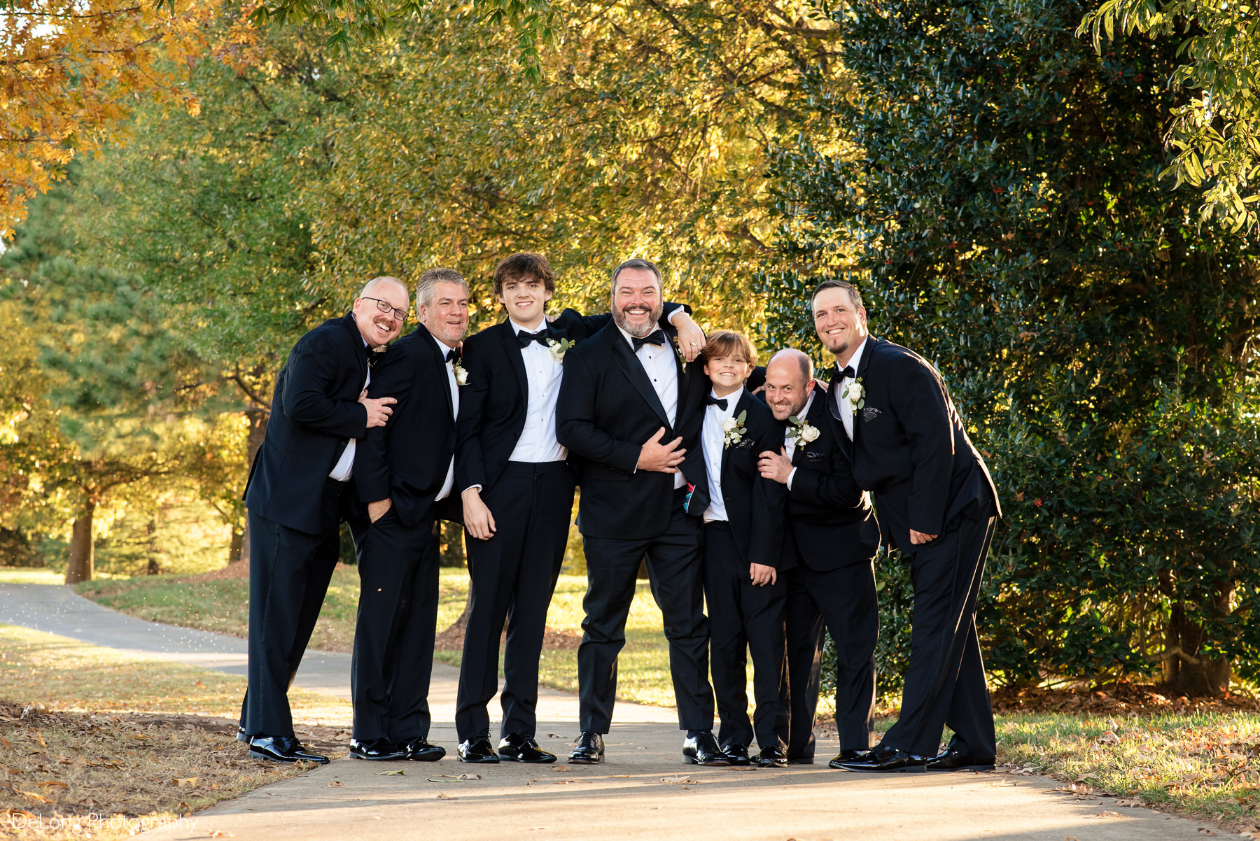 Groom and groomsmen group hug portrait at the Club at Longview by Charlotte Wedding Photographers DeLong Photography