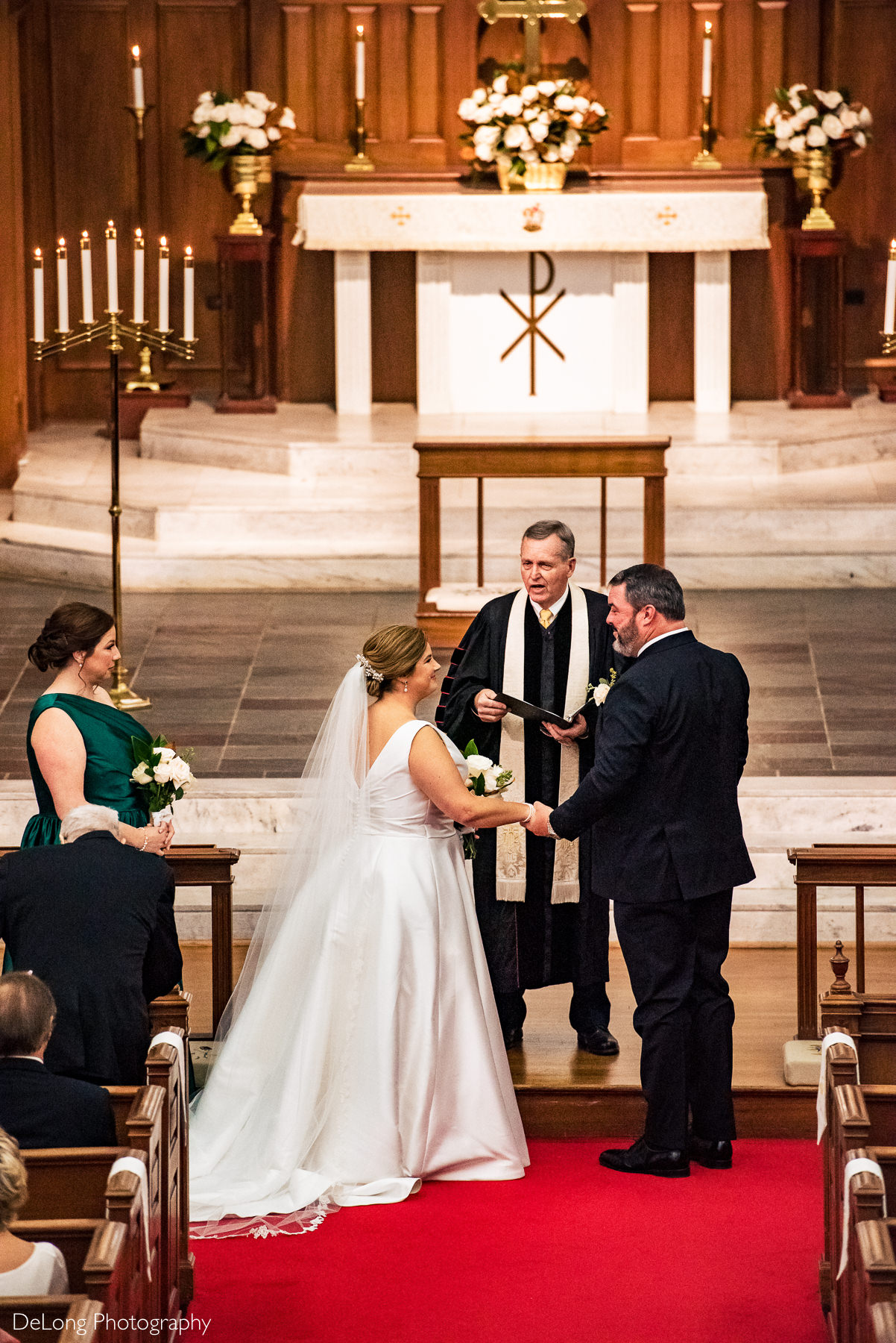 Bride and groom smiling at the altar of Providence Methodist Church by Charlotte Wedding Photographers DeLong Photography