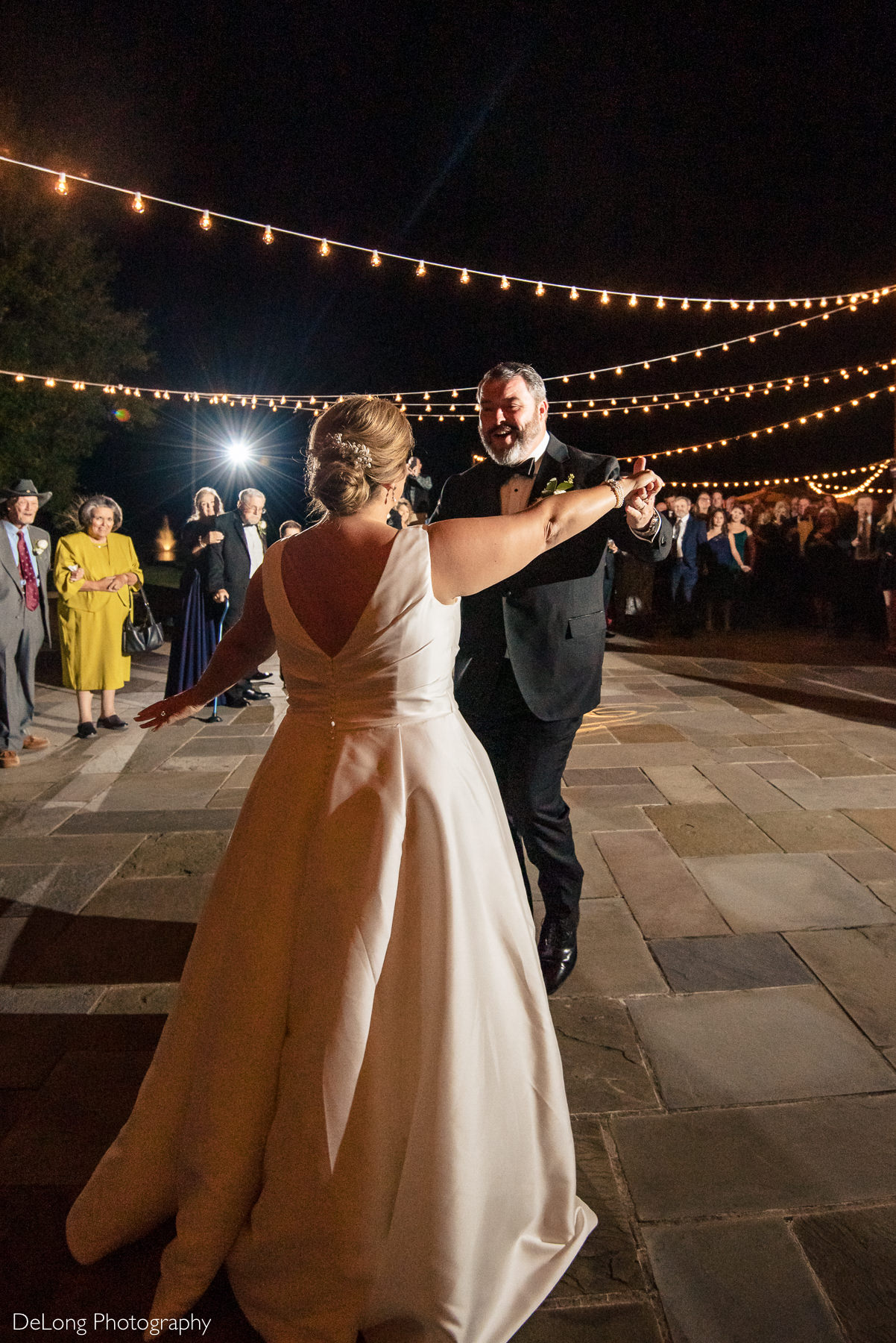 Bride and groom first dance at night on the terrace of the Club at Longview by Charlotte Wedding Photographers DeLong Photography