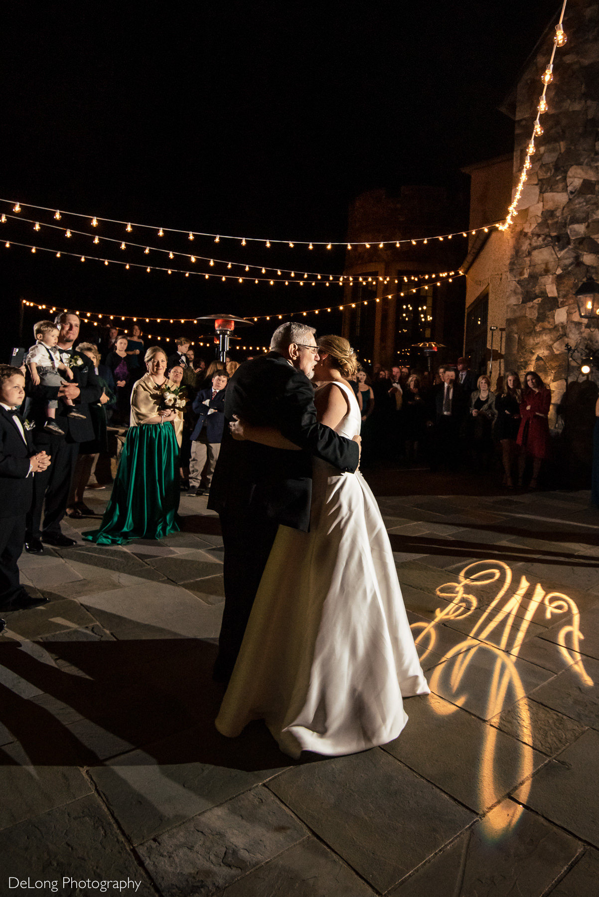 Father-Daughter dance at night on the terrace of the Club at Longview by Charlotte Wedding Photographers DeLong Photography
