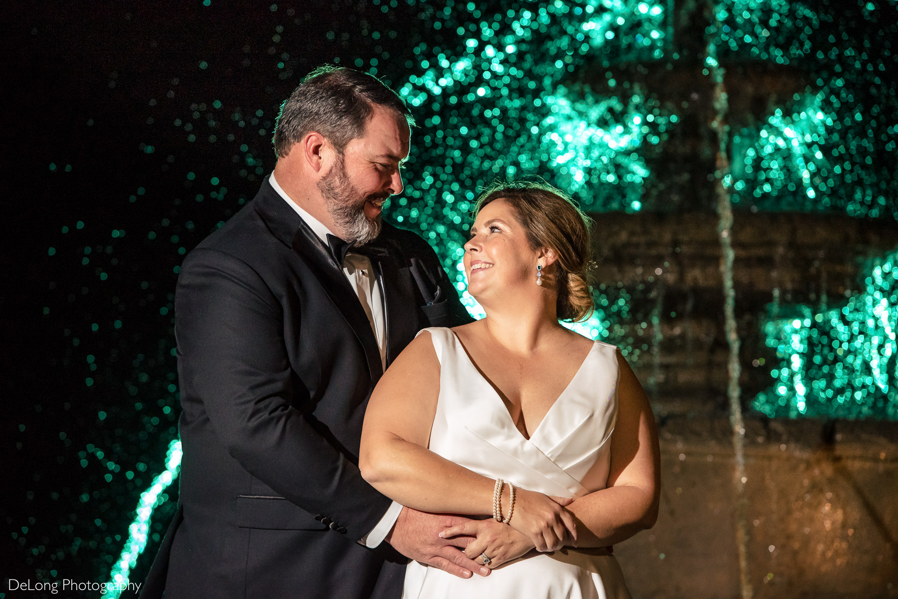 Bride and groom night portrait in front of fountain at The Club at Longview wedding by Charlotte Wedding Photographers DeLong Photography