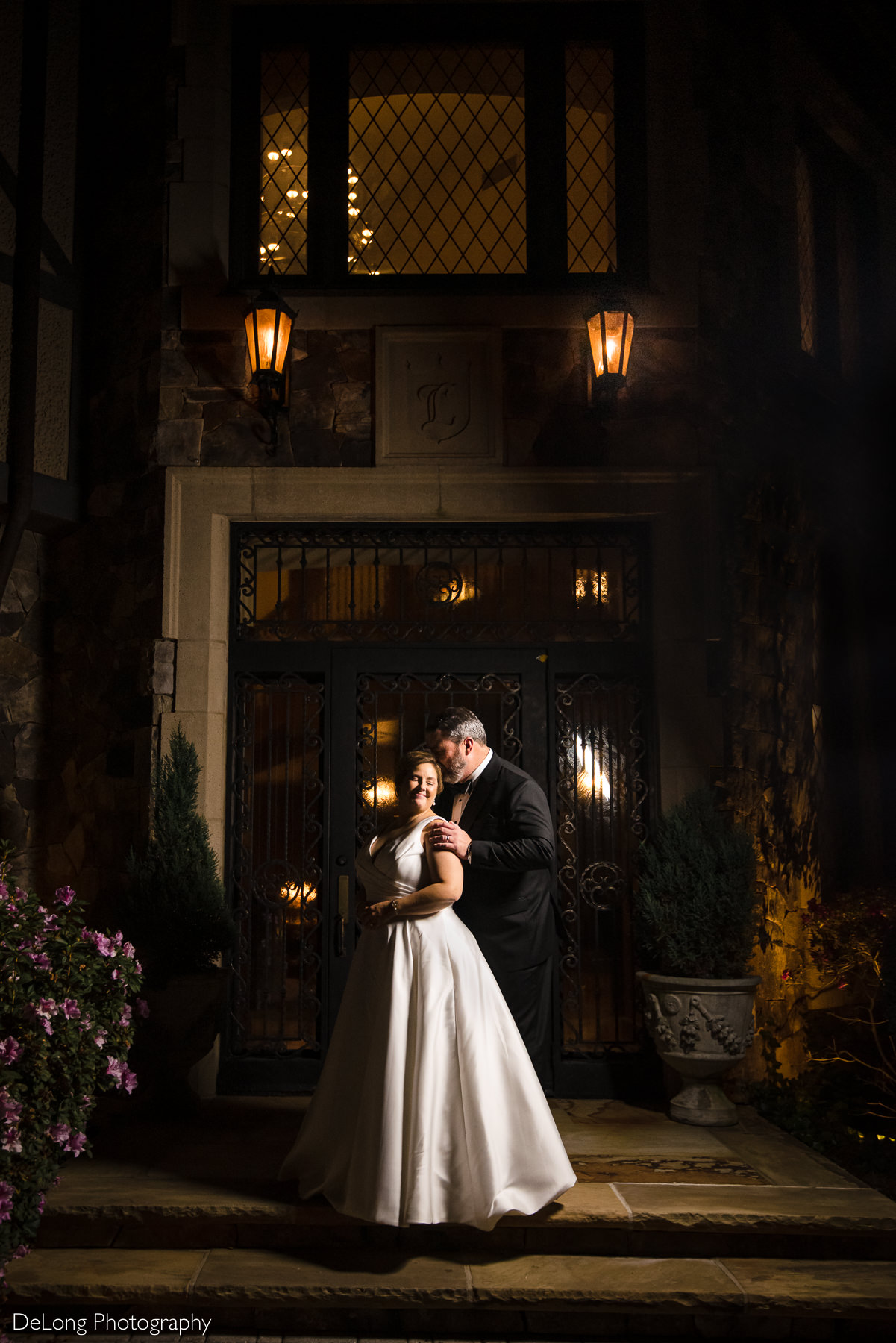 Bride and groom night portrait in front of the iron door at The Club at Longview wedding by Charlotte Wedding Photographers DeLong Photography