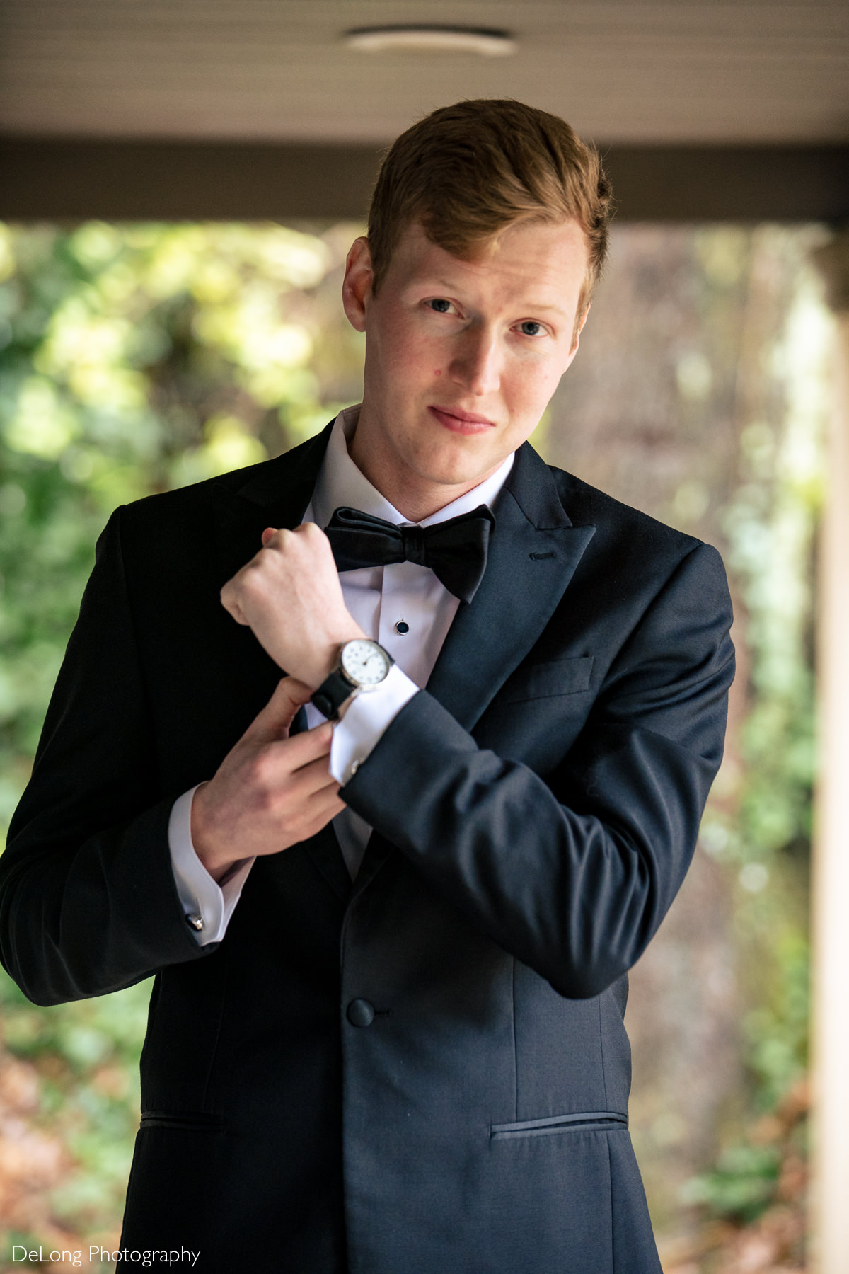 Groom portrait showcasing his new watch by Charlotte wedding photographers DeLong Photography