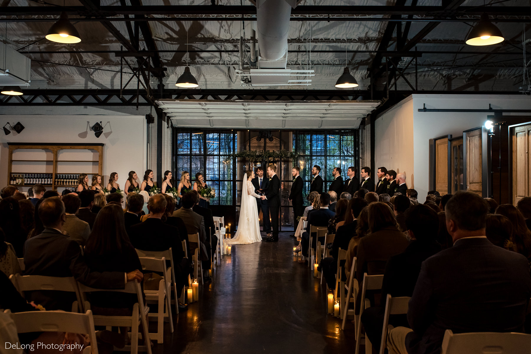 Wide angle view above the seated guests during a wedding ceremony at The Westside Warehouse in Atlanta by Charlotte wedding photographers DeLong Photography