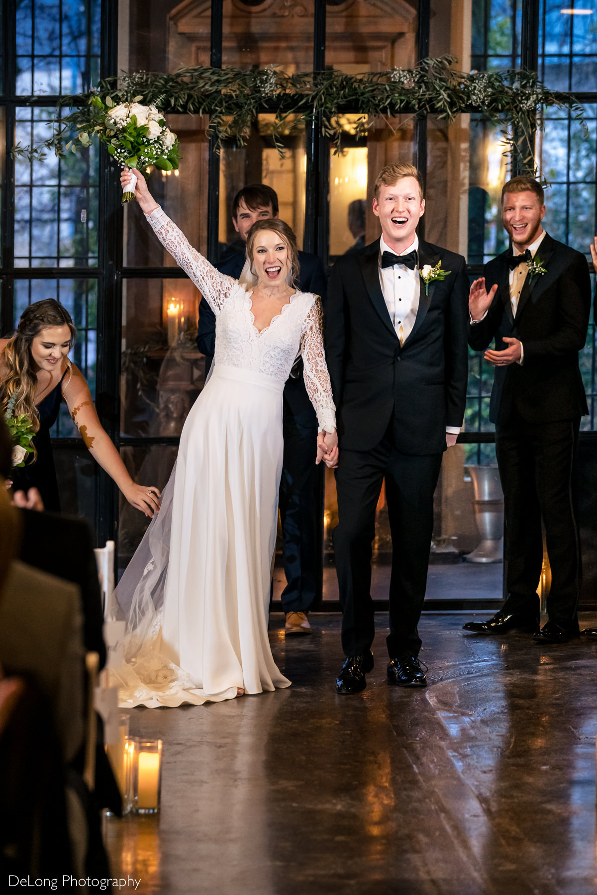 Bride and groom cheering after being married at the Westside warehouse in Atlanta by Charlotte wedding photographers DeLong Photography