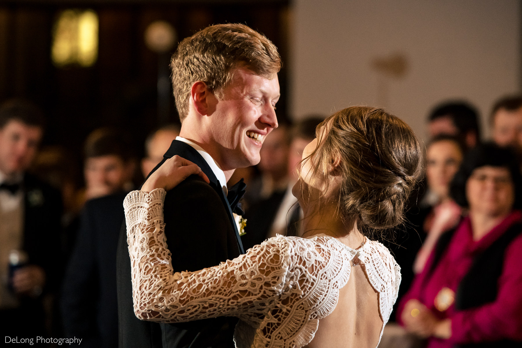 A close up photograph of a groom smiling at his bride during their first dance at the Westside warehouse in Atlanta by Charlotte wedding photographers DeLong Photography
