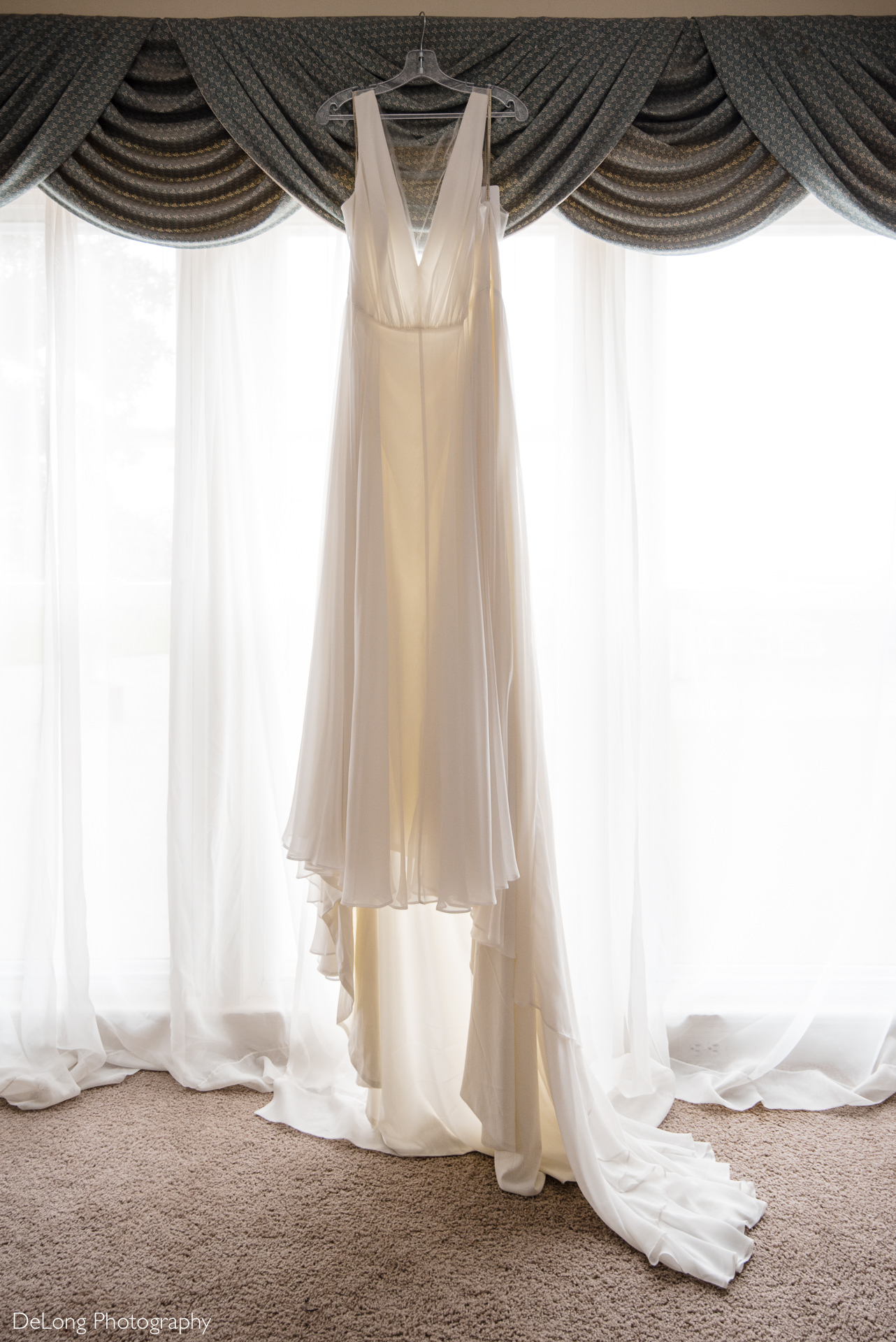 Wedding dress hanging in bridal suite at the Island House by Charlotte Wedding Photographers DeLong Photography