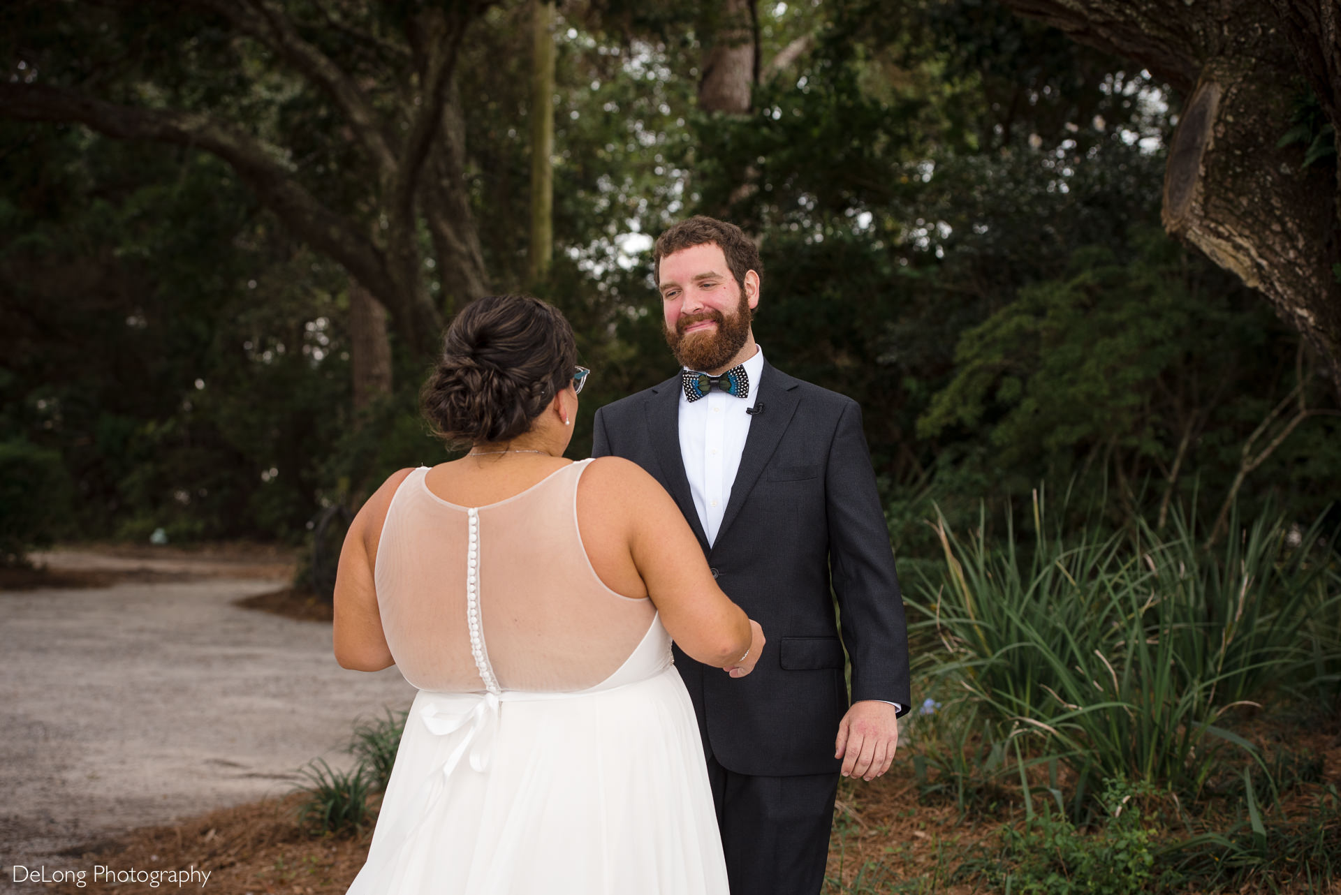 Groom smiling seeing the bride for the first time during a first look at the Island House by Charlotte Wedding Photographers DeLong Photography