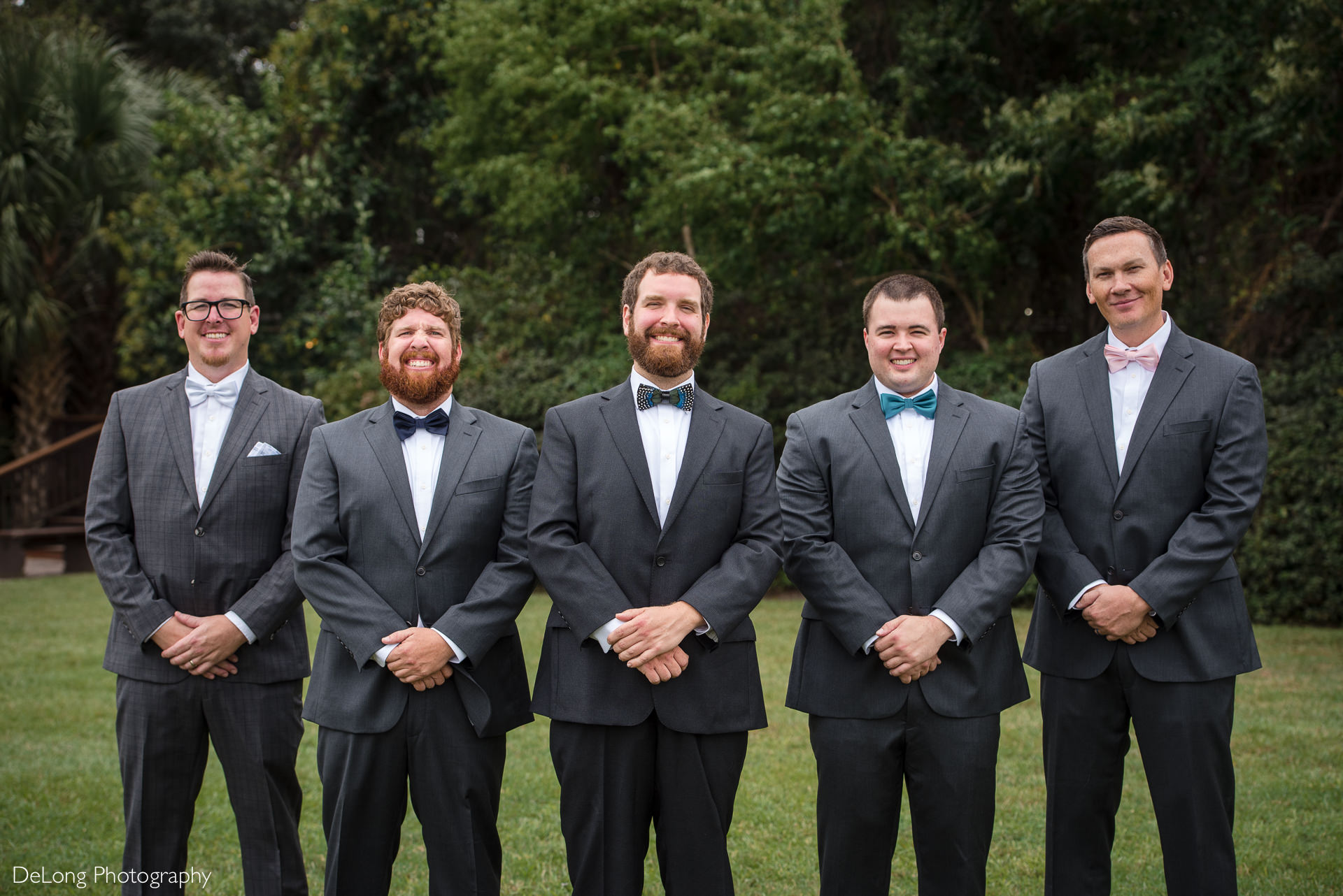 Portrait of groom with groomsmen on the lawn at the Island House in Charleston, SC by Charlotte Wedding Photographers DeLong Photography