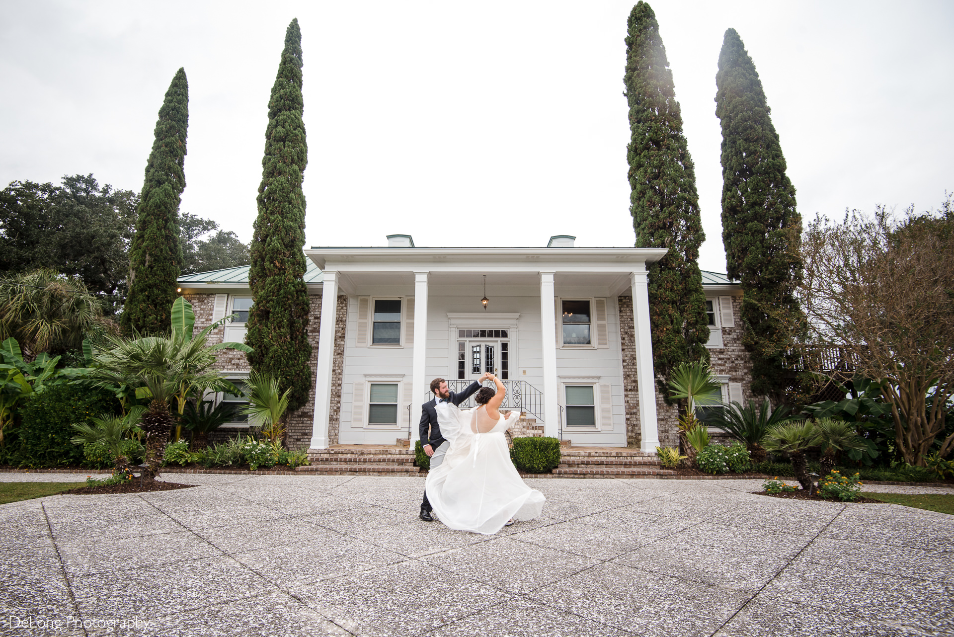 Bride and groom dancing in front of the house at the large oak tree on the property of the Island House in Charleston, SC by Charlotte Wedding Photographers DeLong Photography