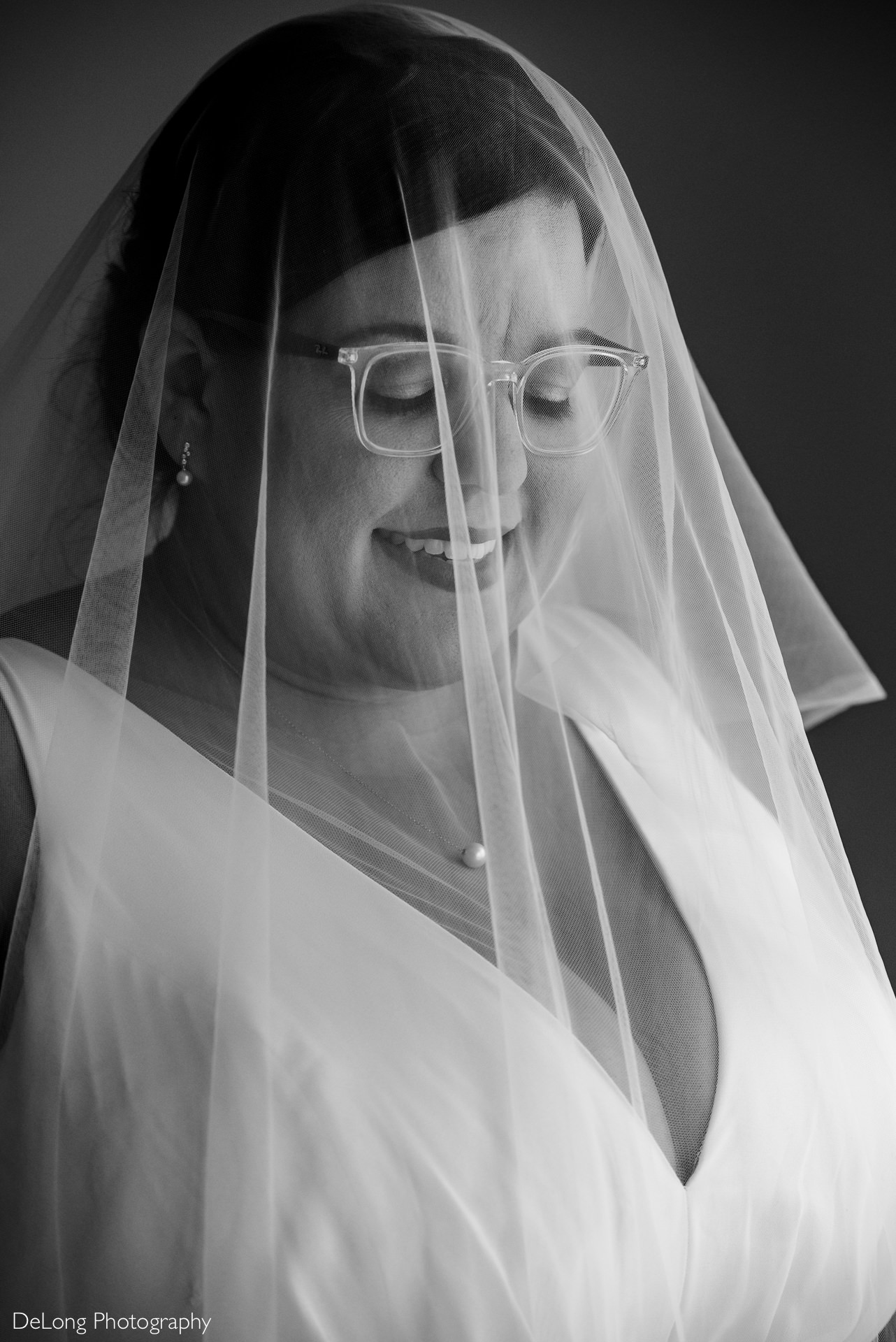 Indoor bridal portrait with the veil over the bride's face at the Island House in Charleston, SC by Charlotte Wedding Photographers DeLong Photography