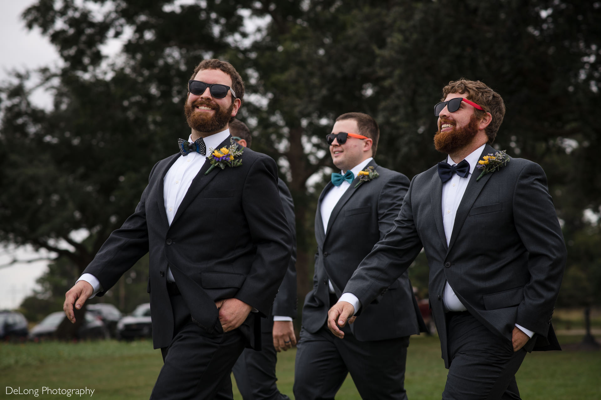 Groom and groomsmen doing a funny ceremony entrance by walking out wearing sunglasses at the Island House in Charleston, SC by Charlotte Wedding Photographers DeLong Photography