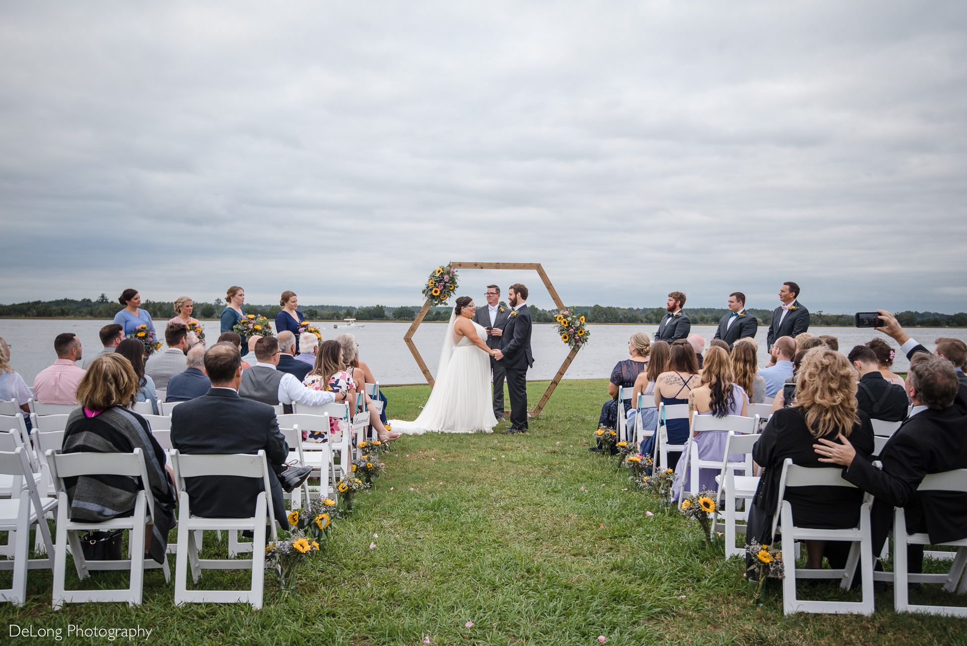 Wedding ceremony by the water at the Island House in Charleston, SC by Charlotte Wedding Photographers DeLong Photography