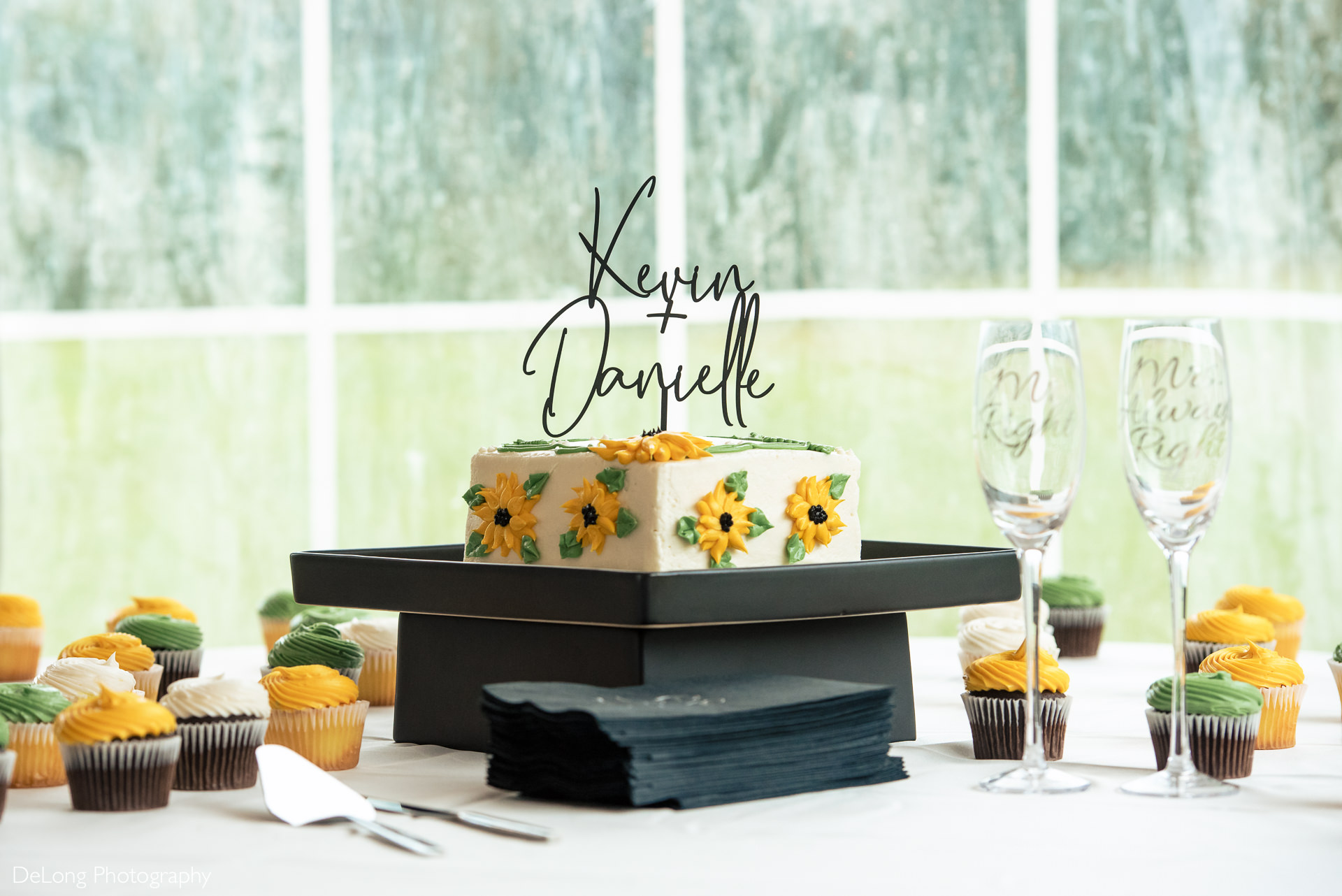 Green and Yellow sunflower wedding cake and cupcakes at the Island House in Charleston, SC by Charlotte Wedding Photographers DeLong Photography