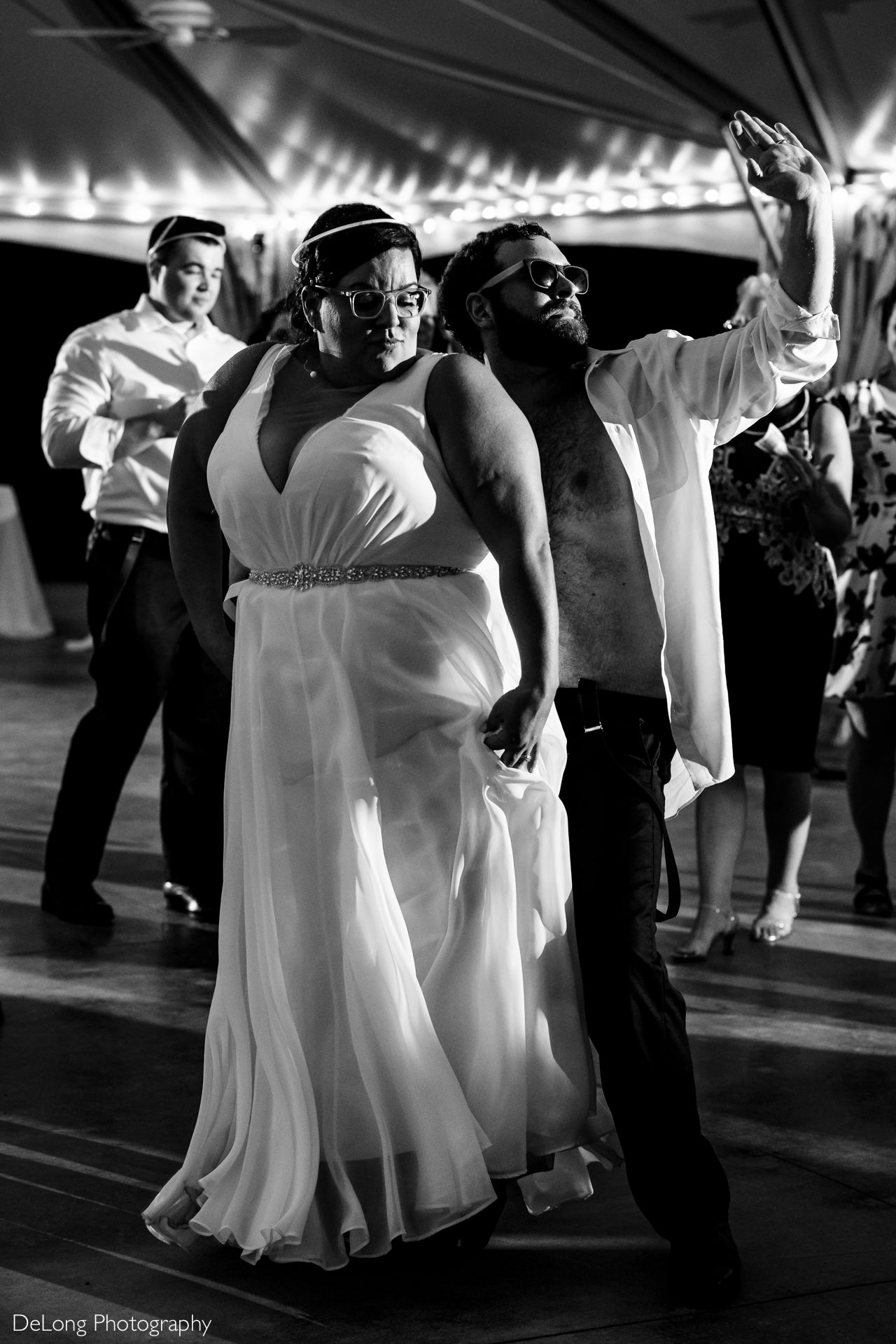 Bride and groom dancing and having fun at their wedding reception at the Island House in Charleston, SC by Charlotte Wedding Photographers DeLong Photography