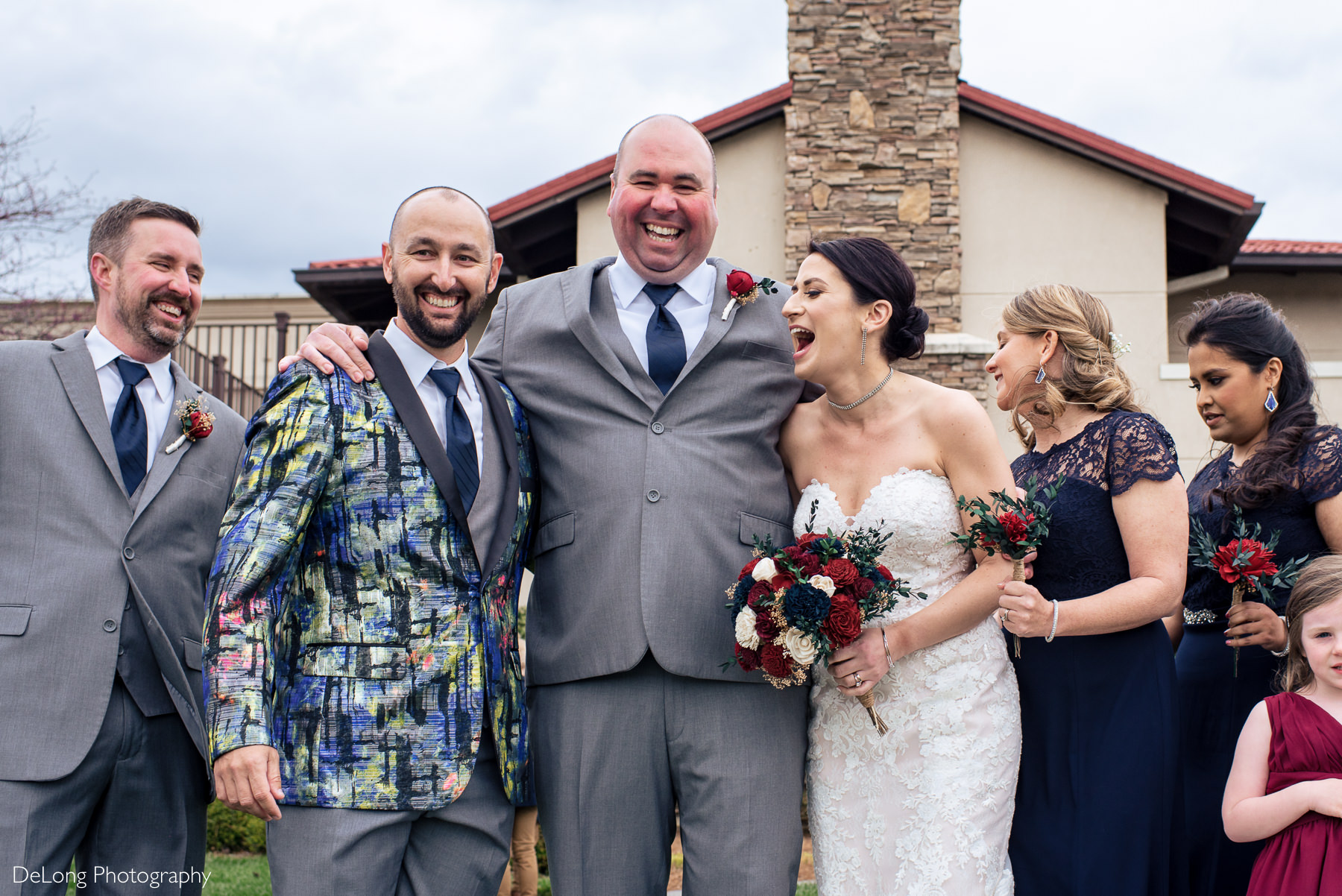 Bride and groom laughing while bride is surprised by obnoxious best man suite at Childress Vineyards by Charlotte Wedding Photographers DeLong Photography