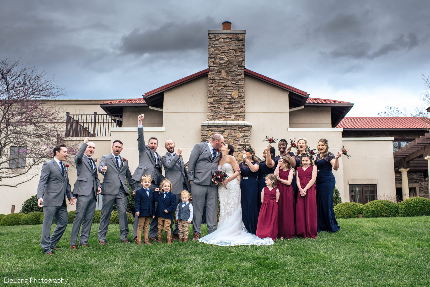 Cheering wedding party portrait at Childress Vineyards by Charlotte Wedding Photographers DeLong Photography