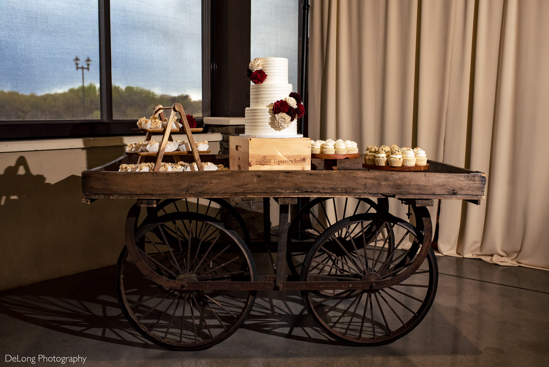 Cake and cupcakes on wagon at Childress Vineyards by Charlotte Wedding Photographers DeLong Photography