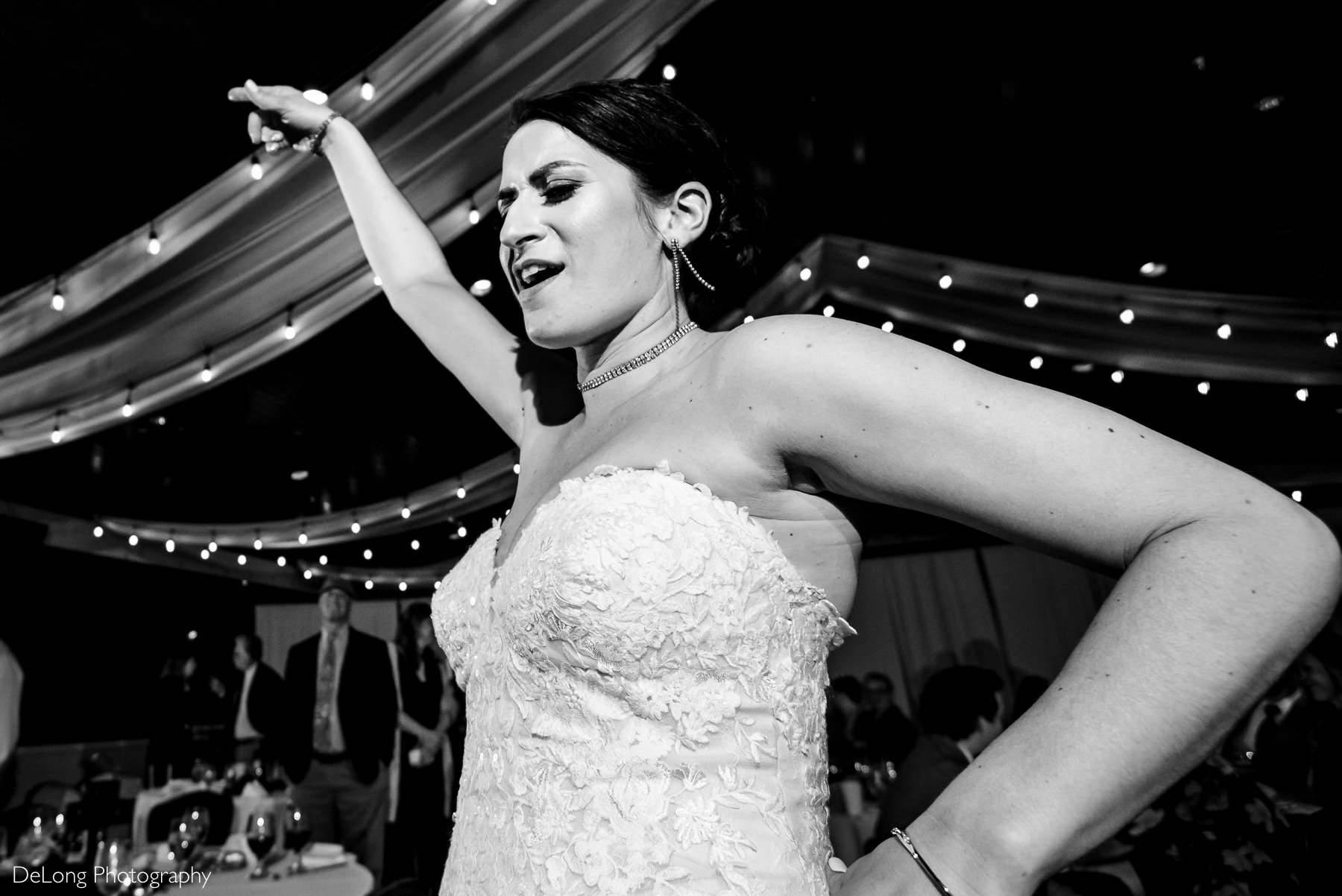 Up close image of bride doing bold dance moves at the reception at Childress Vineyards by Charlotte Wedding Photographers DeLong Photography