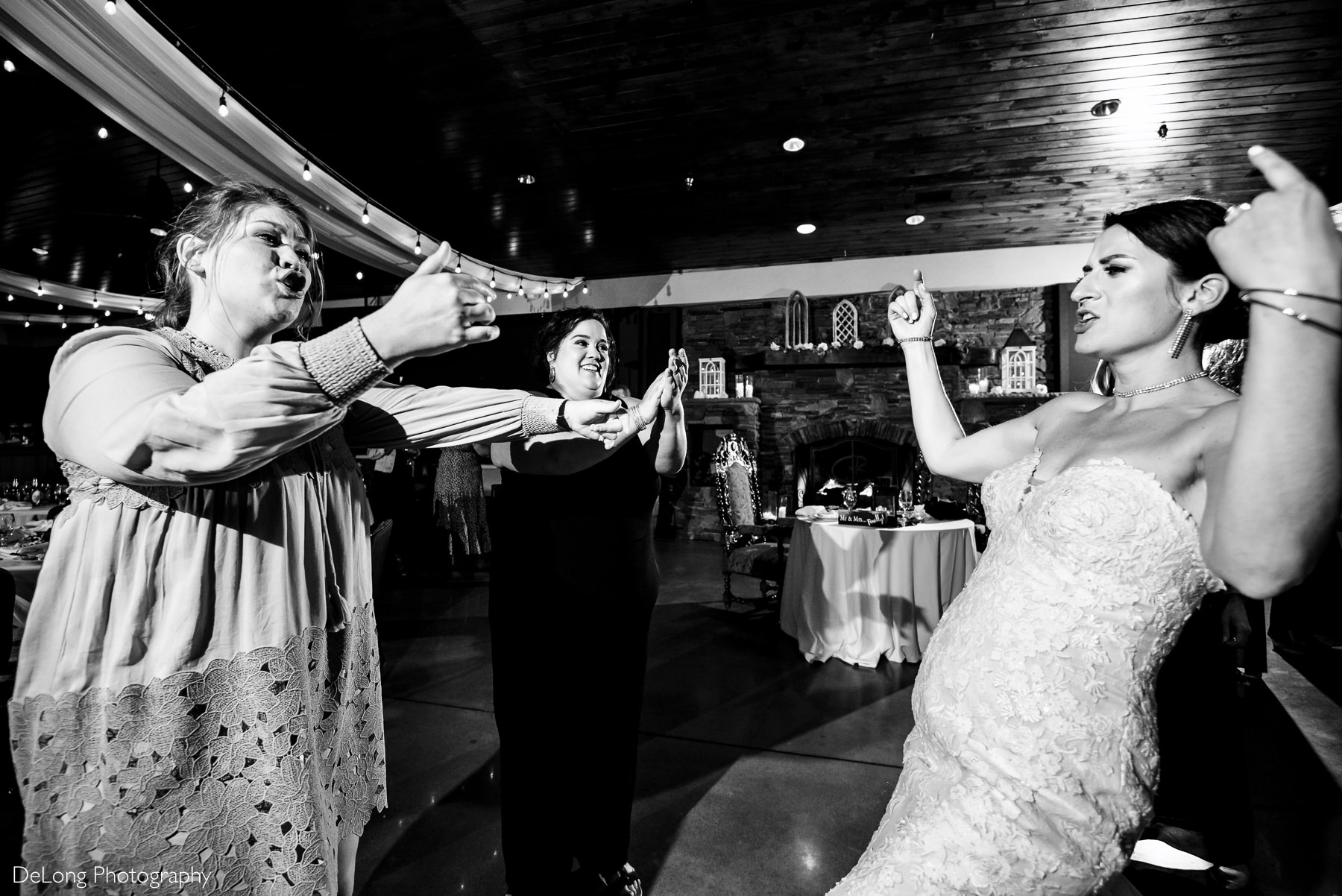 Bride and friends belting out lyrics and dancing to music during the reception at Childress Vineyards by Charlotte Wedding Photographers DeLong Photography