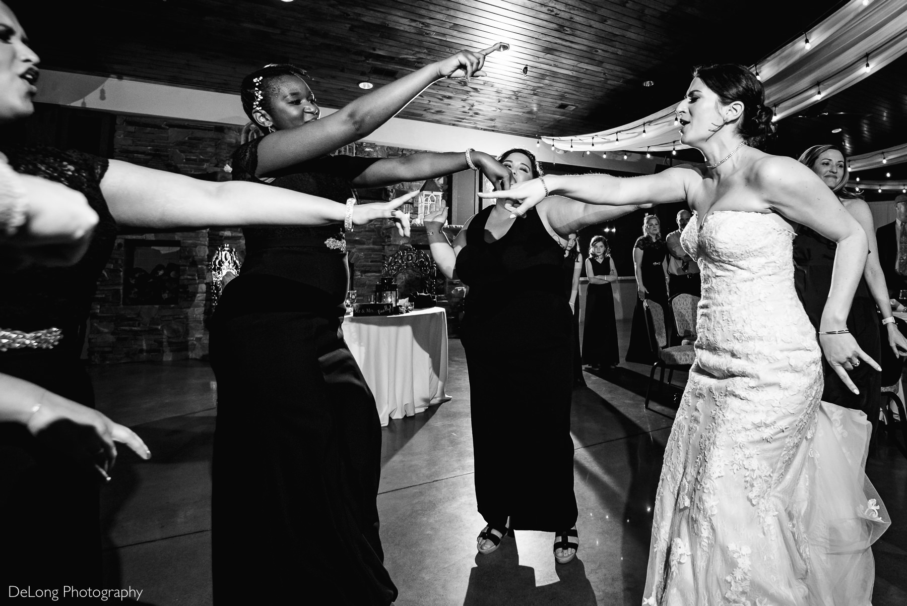 Bride and friends belting out lyrics and dancing to music during the reception at Childress Vineyards by Charlotte Wedding Photographers DeLong Photography
