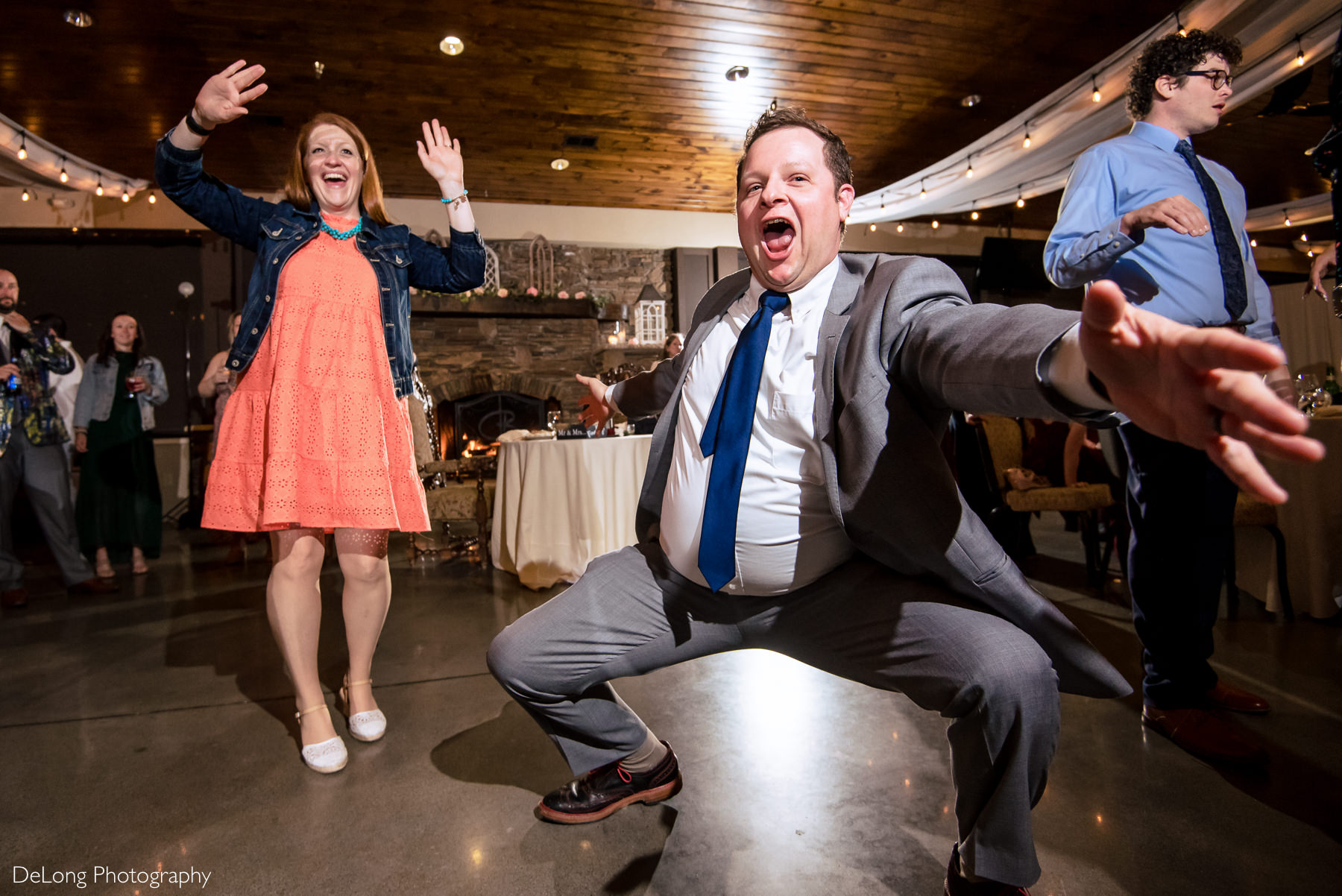 Up close image of man dancing low on the dancing floor during reception at Childress Vineyards by Charlotte Wedding Photographers DeLong Photography