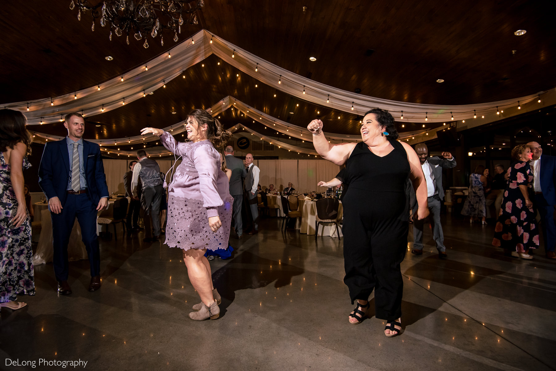 Guests doing a choreographed dance during a reception at Childress Vineyards by Charlotte Wedding Photographers DeLong Photography