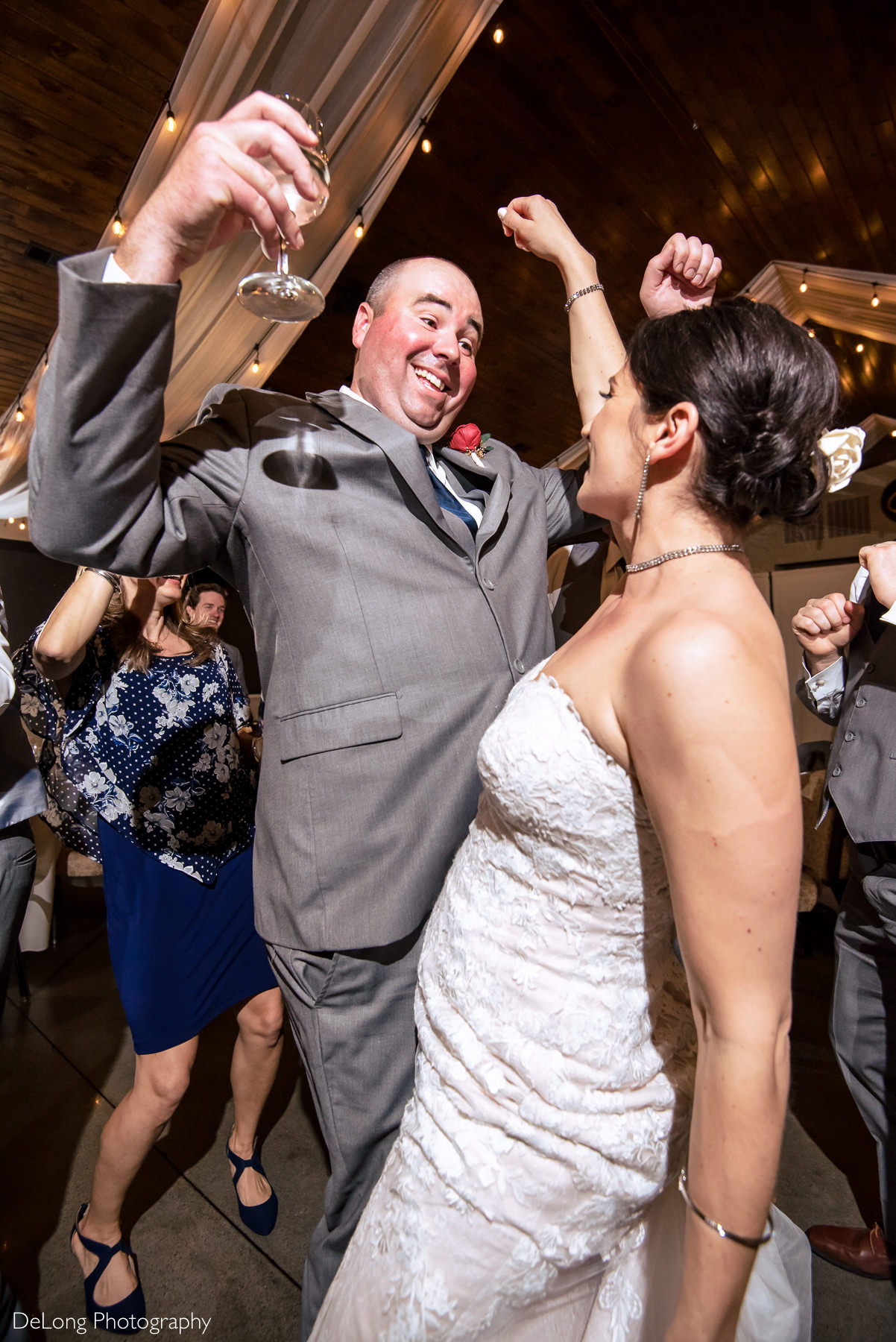 Up close image of bride and groom breaking it down on the dance floor during their reception at Childress Vineyards by Charlotte Wedding Photographers DeLong Photography