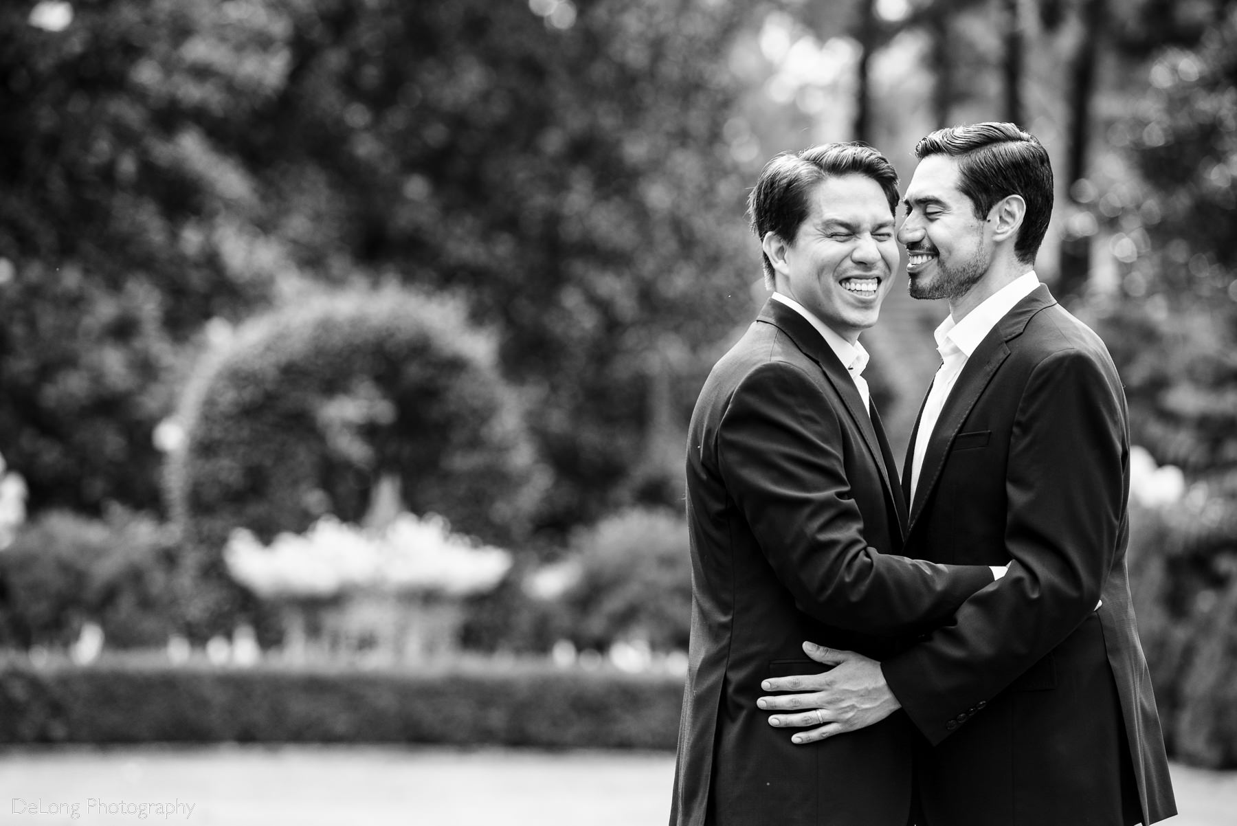Candid laughing photograph of two grooms before their elopement at the Duke Mansion by Charlotte wedding photographers DeLong Photography