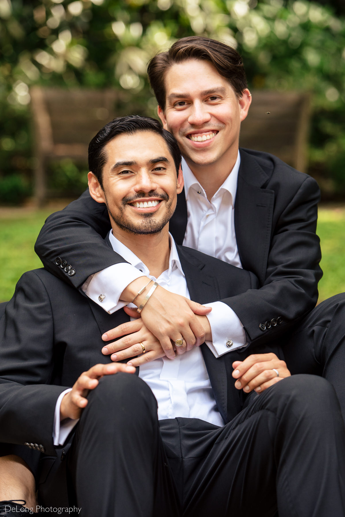 Seated portrait of gay couple at the Duke Mansion by Charlotte wedding photographers DeLong Photography
