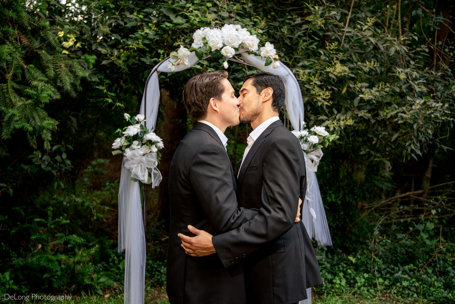 First kiss during same-sex elopement by Charlotte wedding photographers DeLong Photography