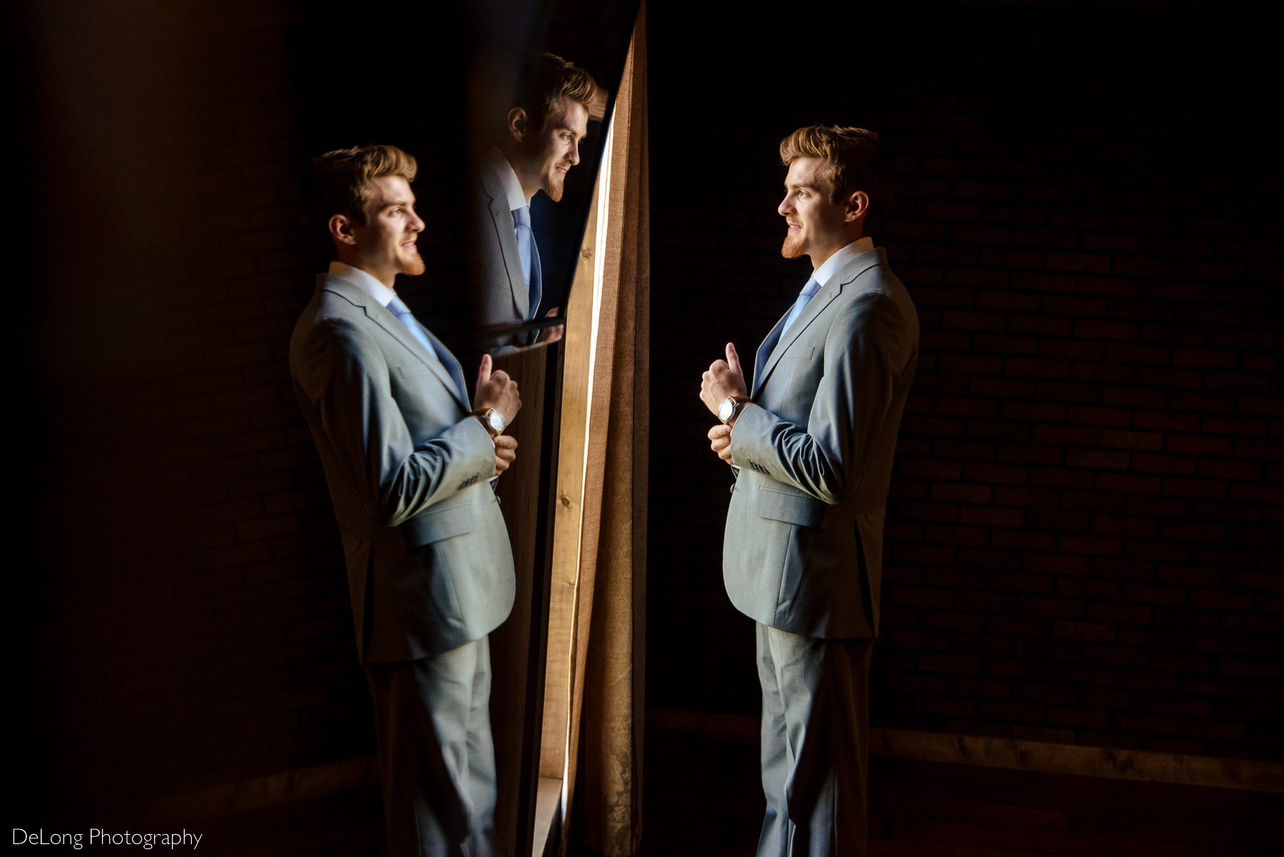 Triple reflection of groom in the groom's suite at by Charlotte Wedding Photographers DeLong Photography