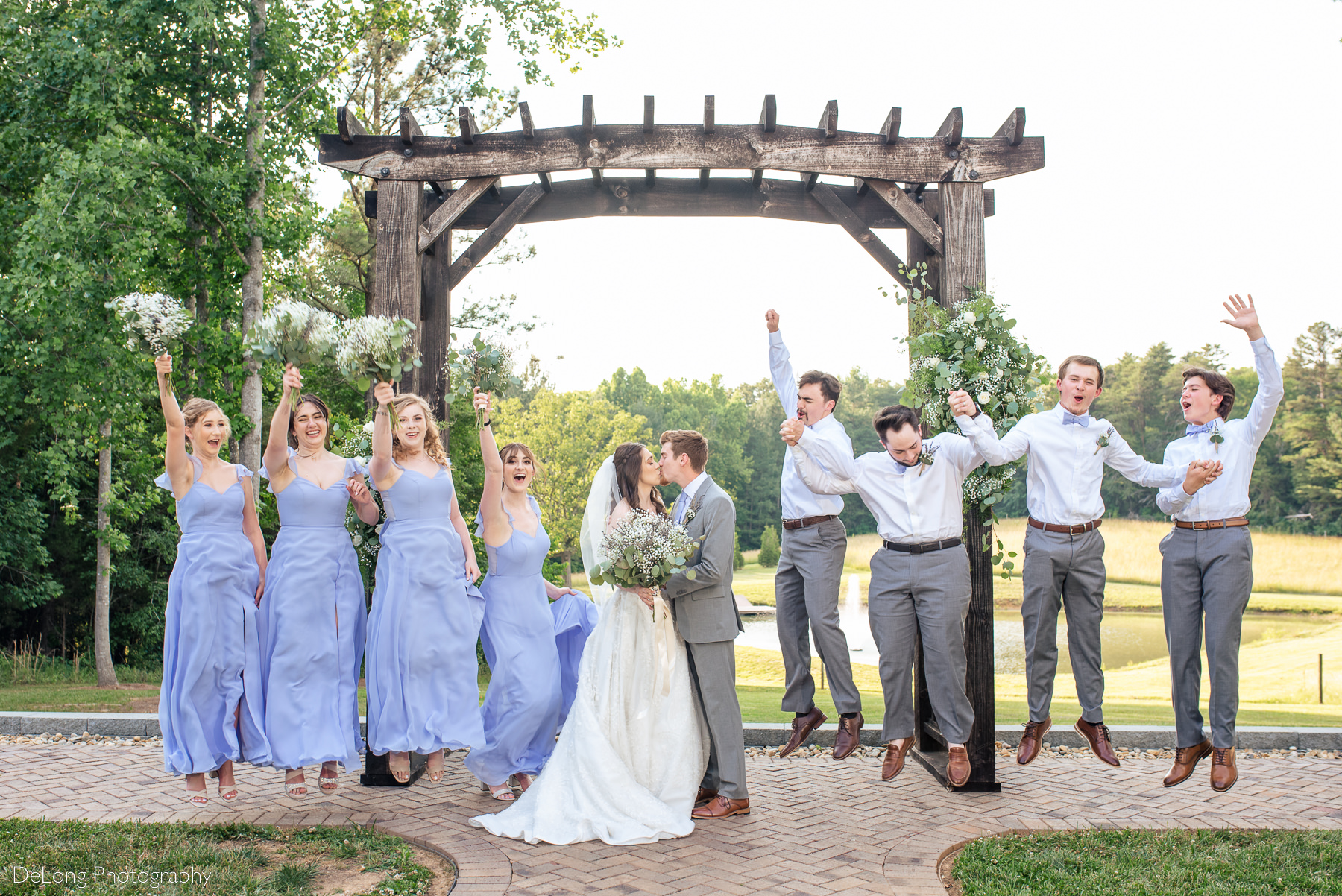 Fun jumping photo of wedding party at Lady Bird Farms