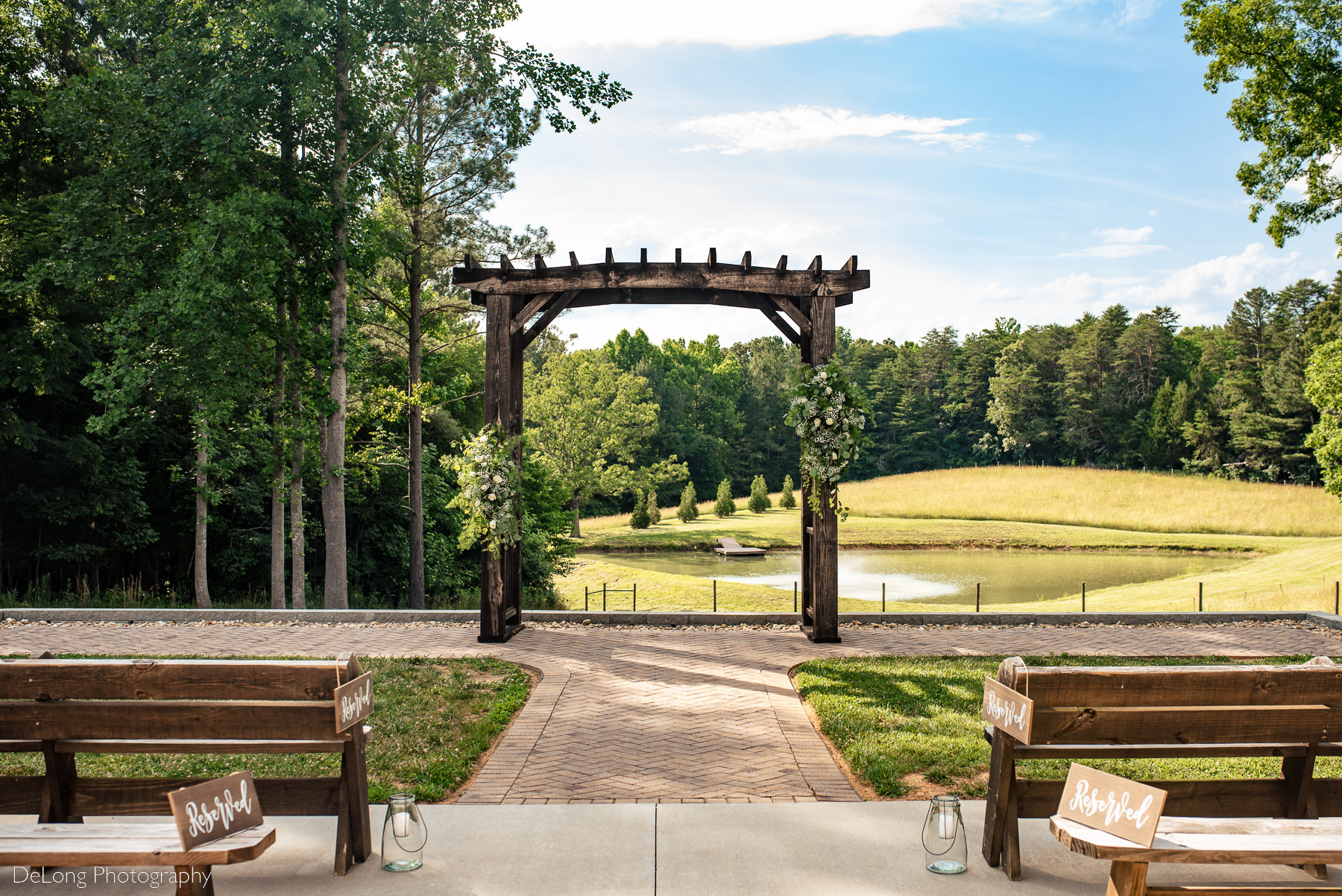 Outdoor arbor and wedding ceremony space facing the pond at Lady Bird Farms by Charlotte Wedding Photographers DeLong Photography