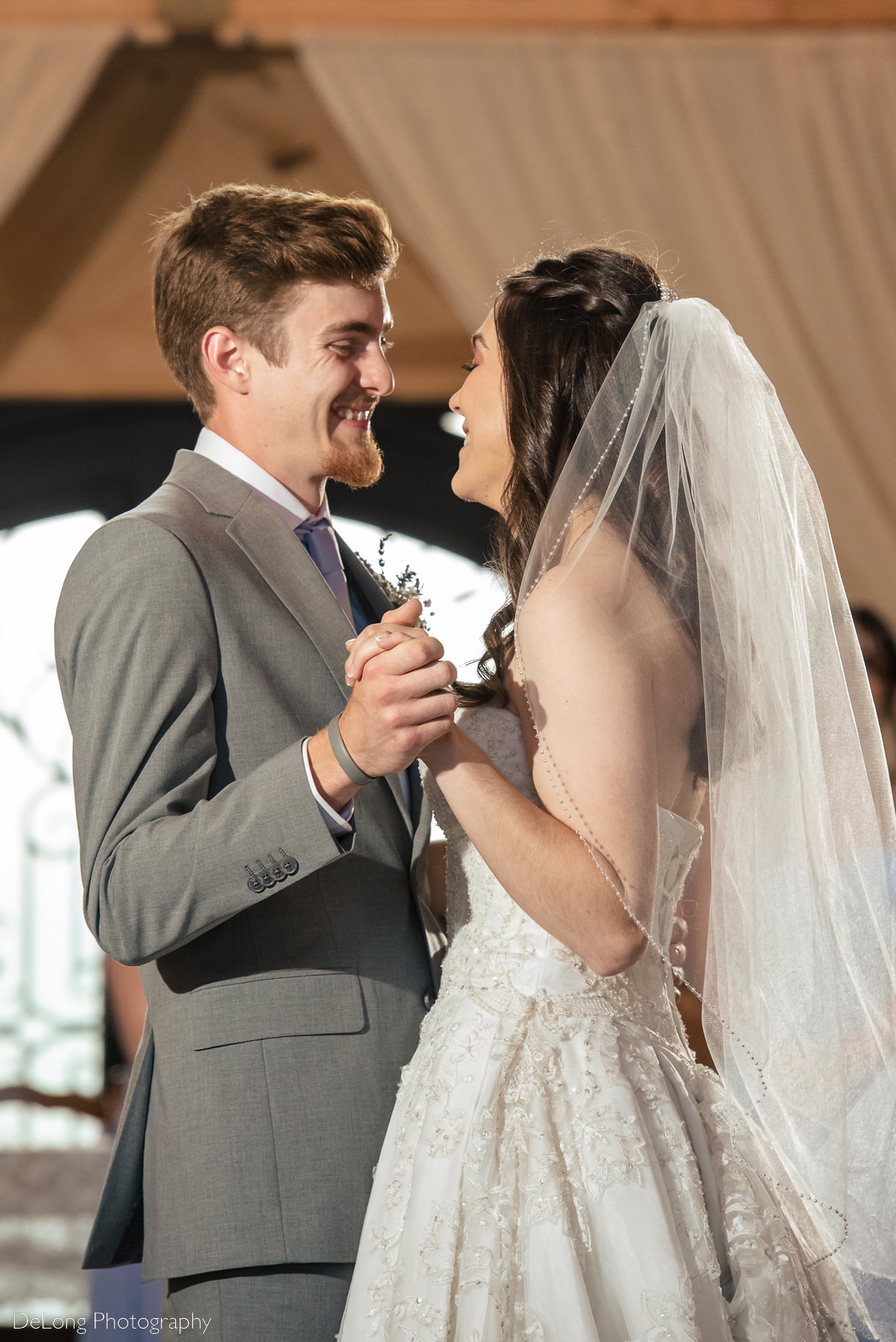 Bride and groom laughing together during their first dance at Lady Bird Farms by Charlotte Wedding Photographers DeLong Photography