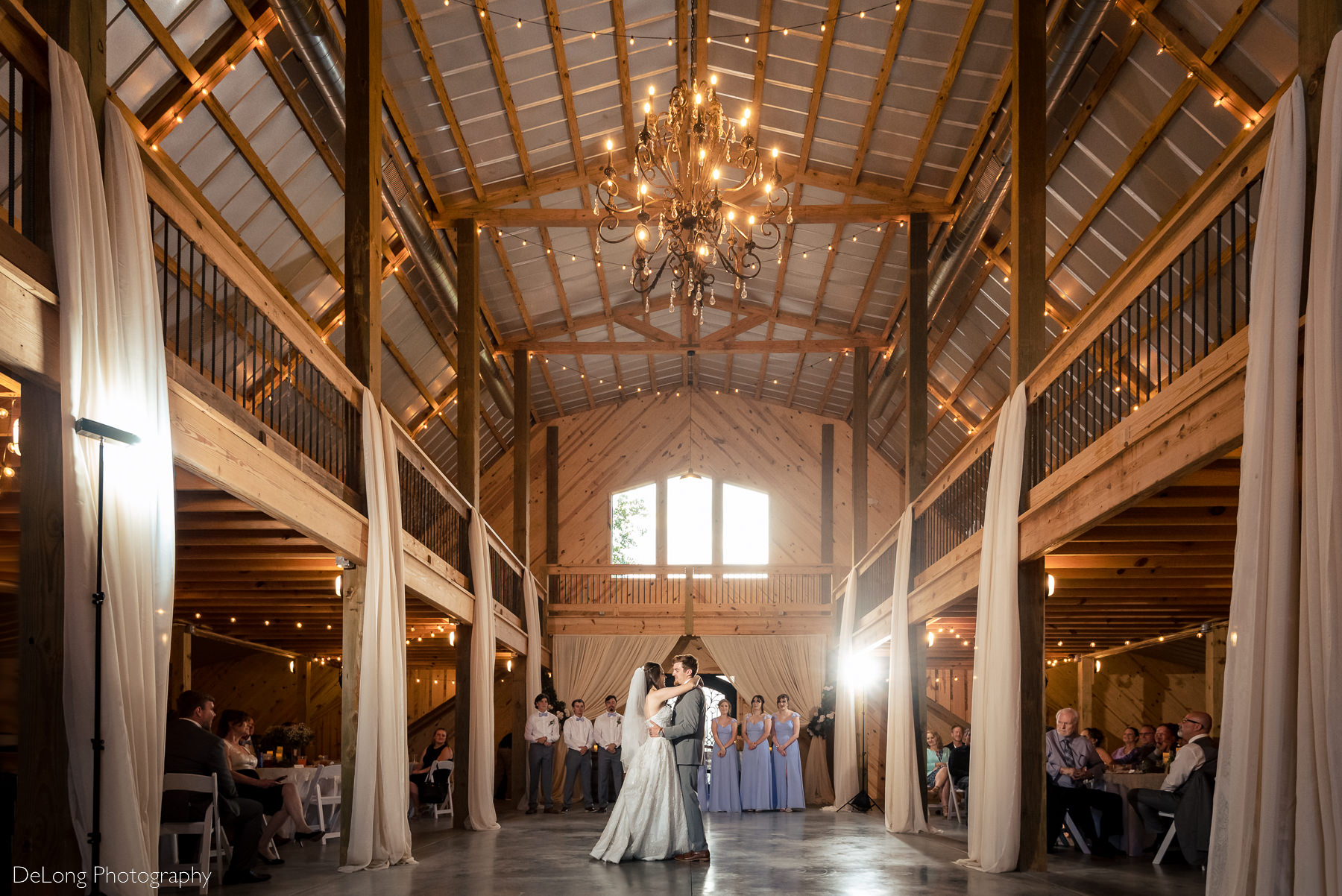 Wide angle photograph of a bride and groom during their first dance at Lady Bird Farms by Charlotte Wedding Photographers DeLong Photography