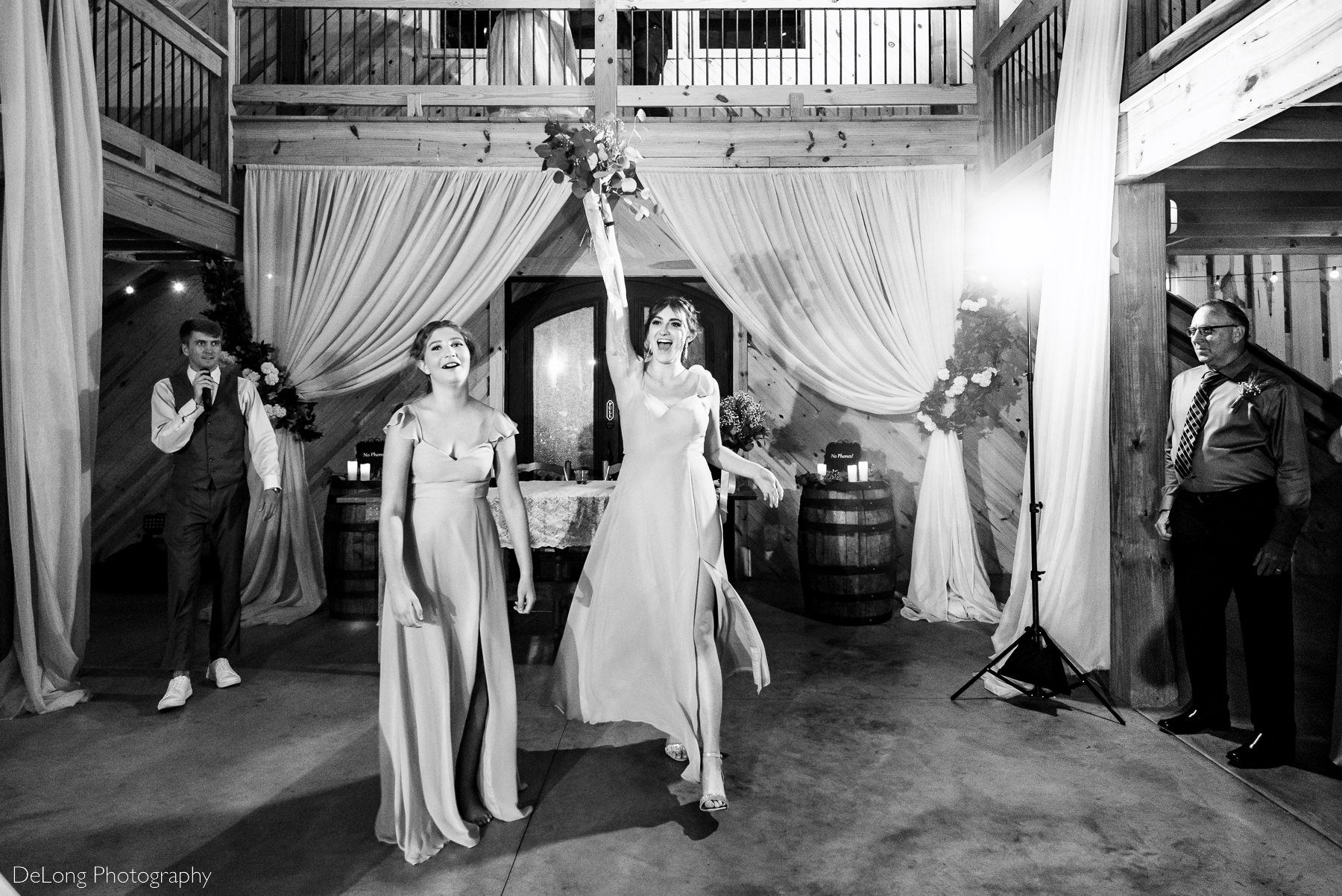 Black and white reaction image of bridesmaid who caught the bride's bouquet at Lady Bird Farms by Charlotte Wedding Photographers DeLong Photography