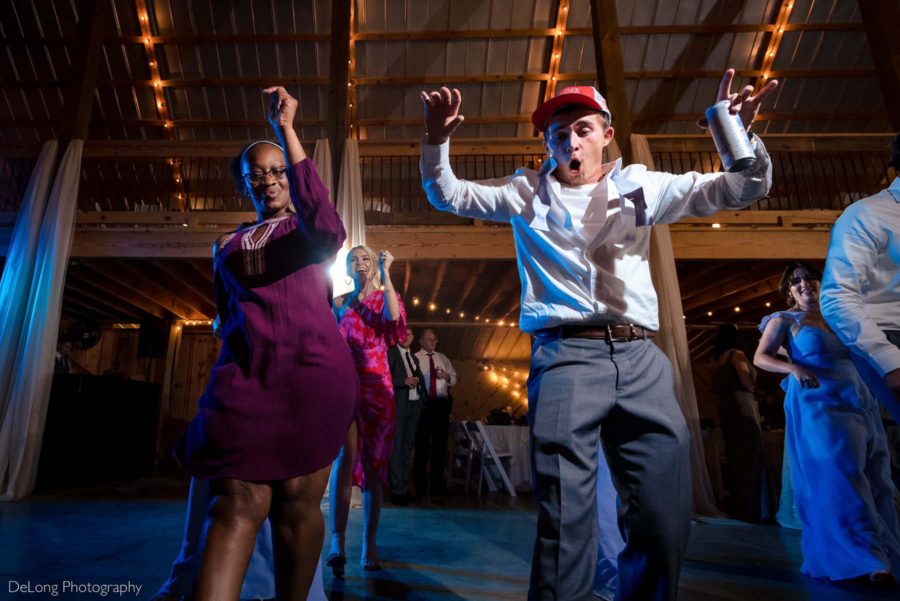 Fun low perspective dancing image during wedding reception at Lady Bird Farms by Charlotte Wedding Photographers DeLong Photography