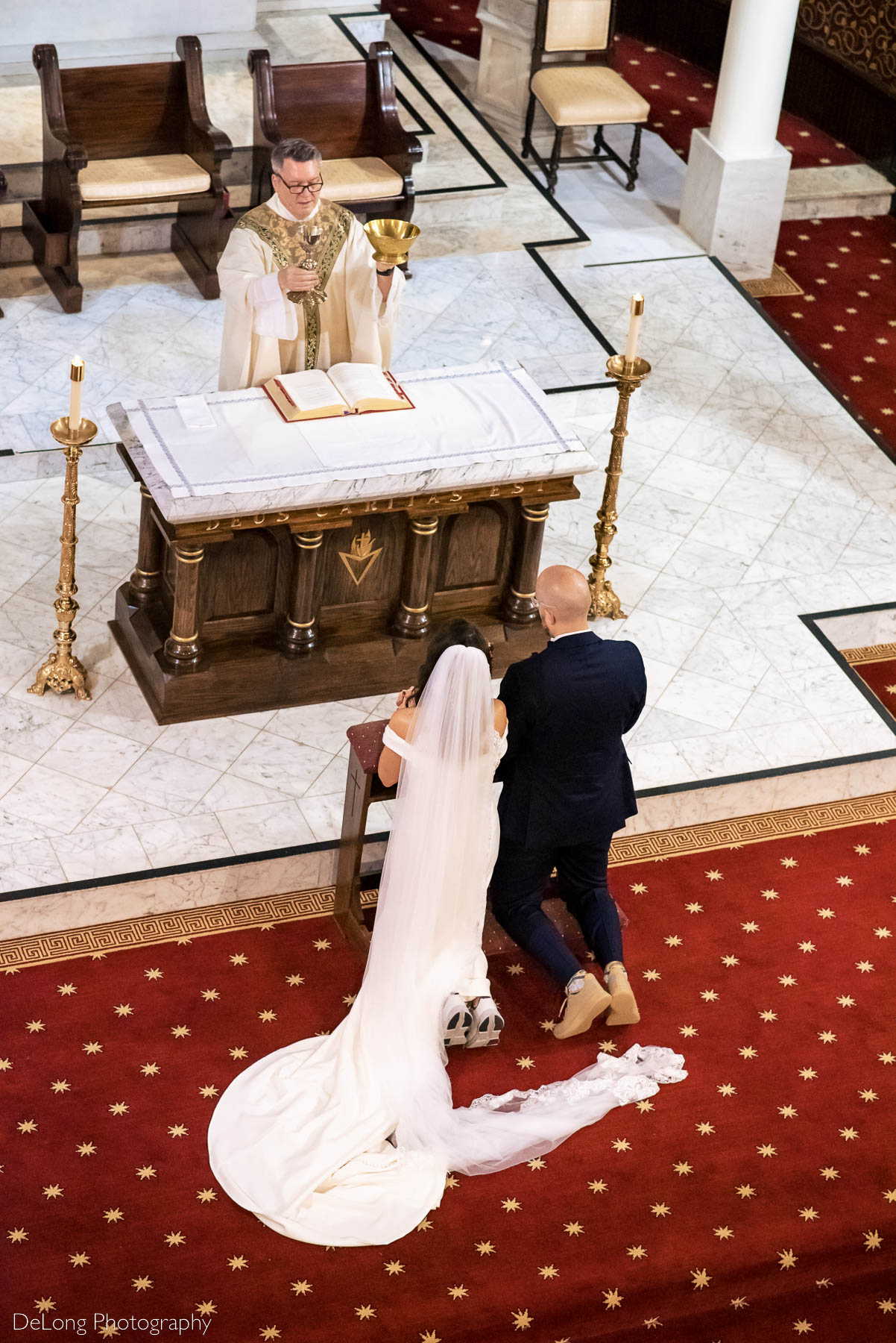 Balcony view of a bride and groom receiving communion at the Basilica of the Sacred Heart of Jesus in Atlanta, GA by Charlotte wedding photographers DeLong Photography 