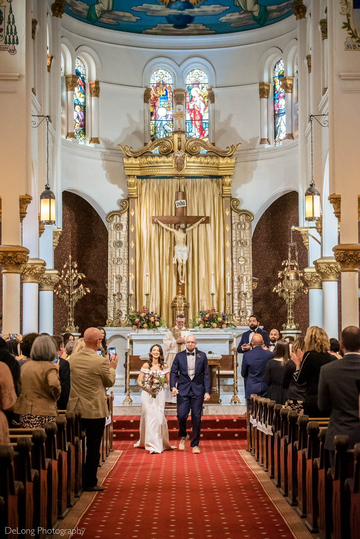 Bride and groom recessing down the aisle at the Basilica of the Sacred Heart of Jesus in Atlanta, GA by Charlotte wedding photographers DeLong Photography 