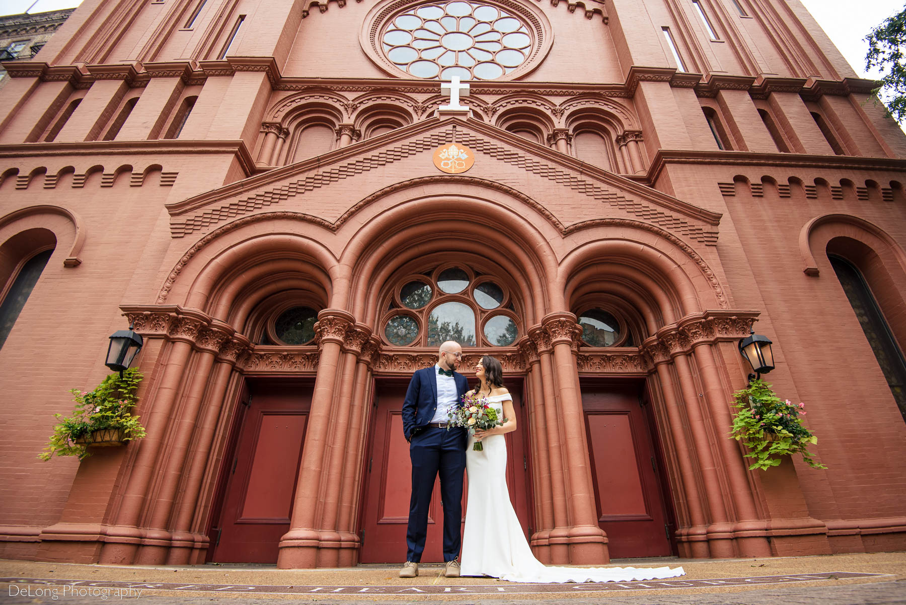A ground-level portrait aimed upwards outside the Basilica of the Sacred Heart of Jesus in Atlanta, GA by Charlotte wedding photographers DeLong Photography